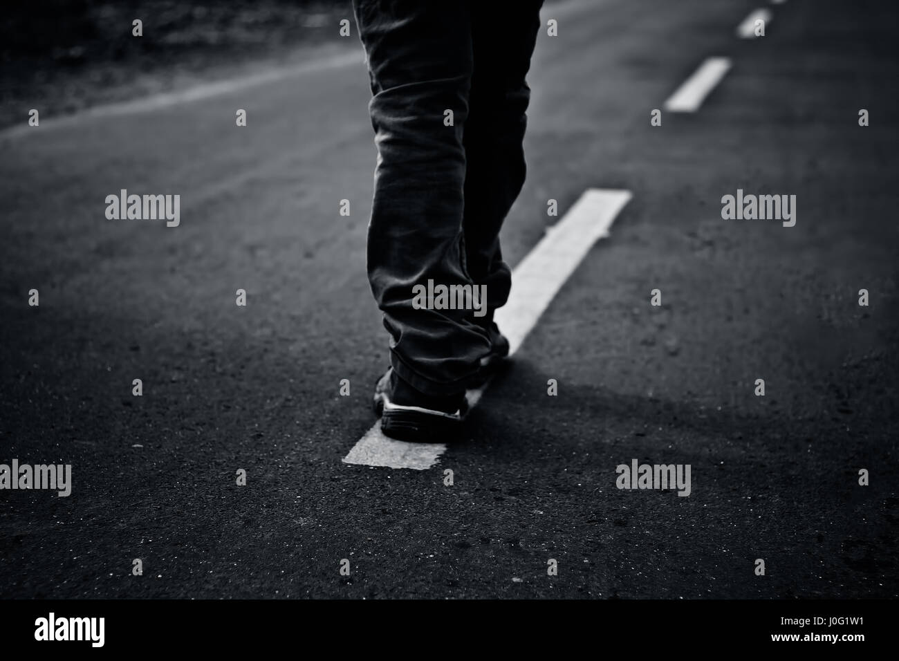 The road less travel. Human figure walking on the road and get two ...