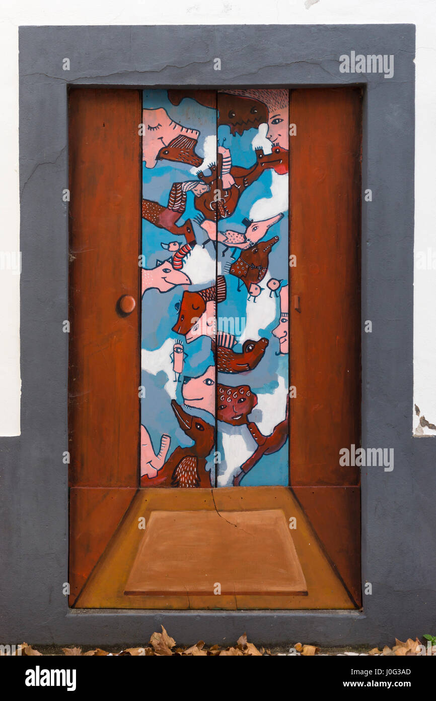 A painting on a door of a doorway to an abstract world in Machico, Madeira Stock Photo