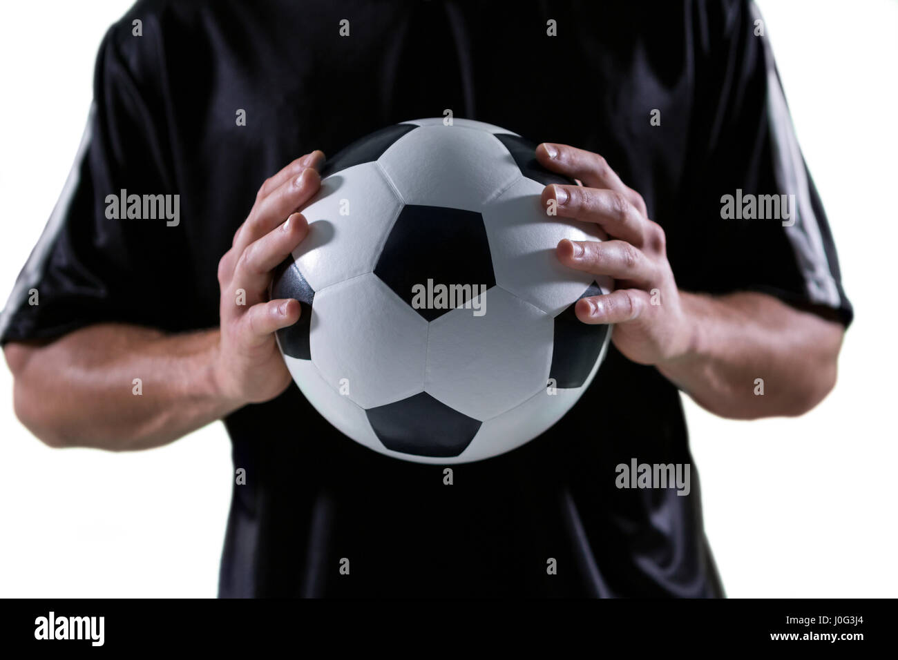 Football Player Holding Football With Both Hands Stock Photo