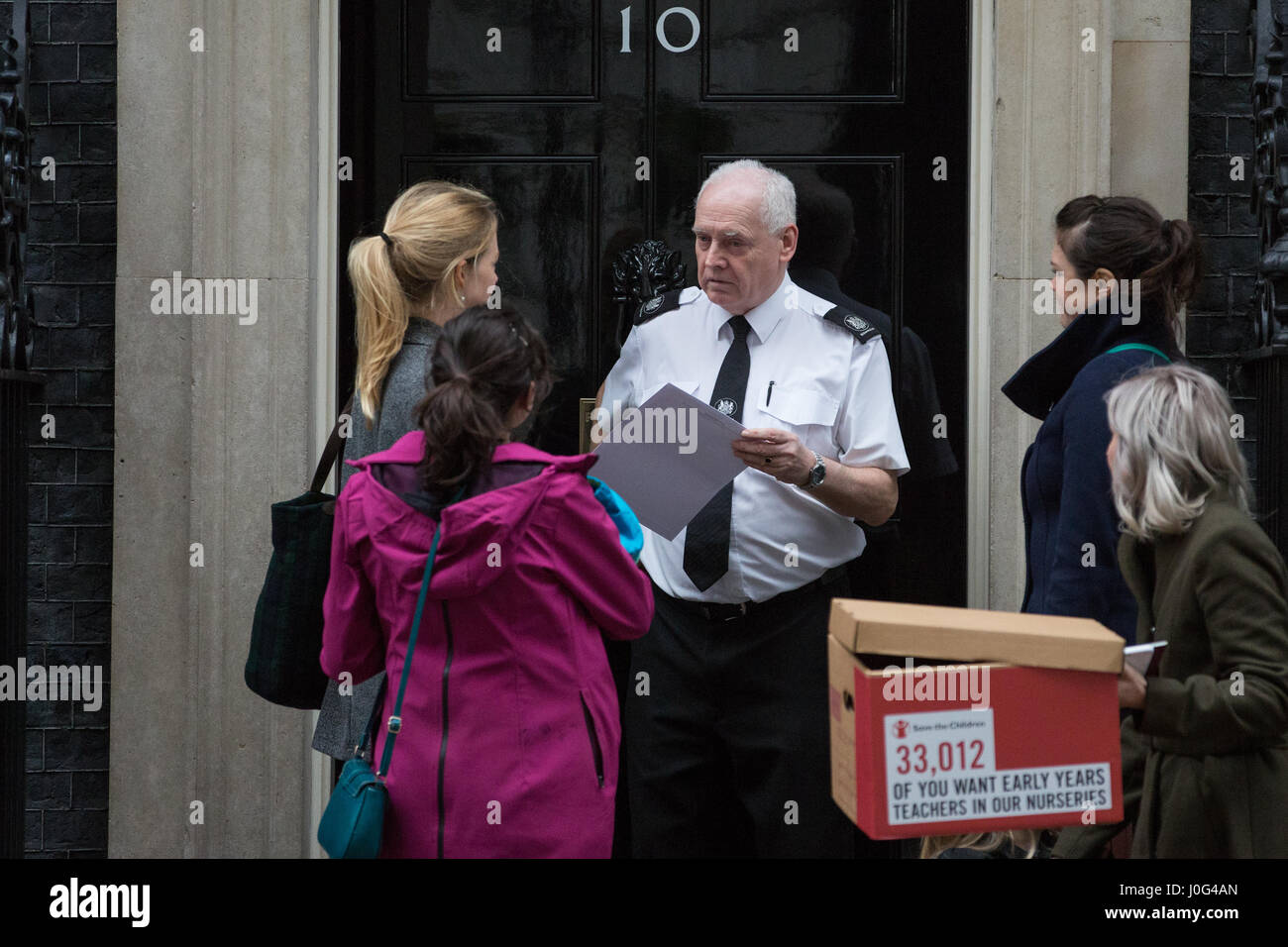 London, UK. 22nd February, 2017. Campaigners from Save The Children present a petition at 10 Downing Street for early years teachers in nurseries sign Stock Photo