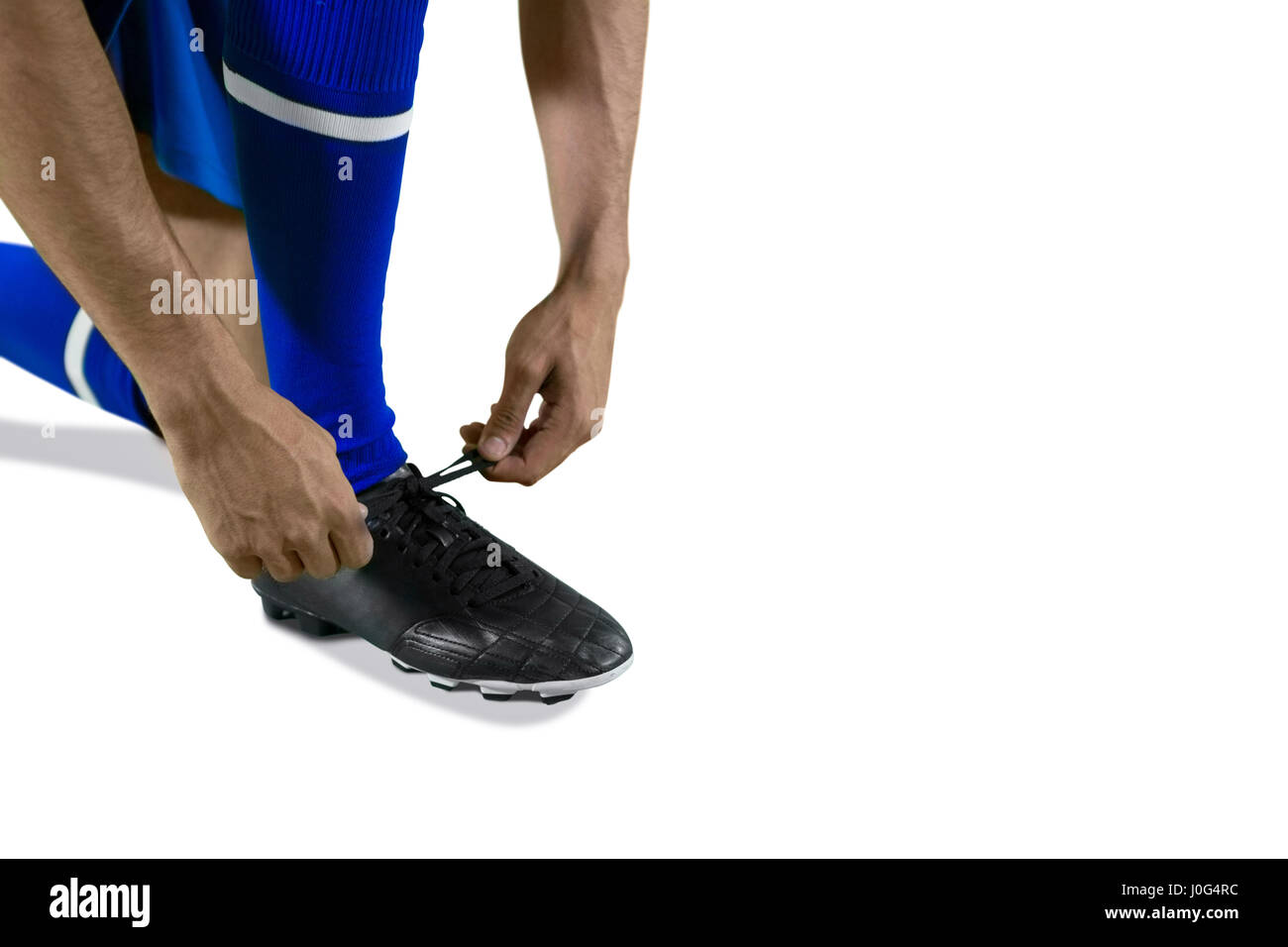 Football player tying his shoe lace against white background Stock Photo Alamy