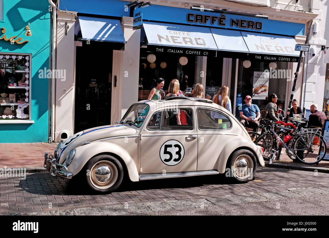 Old Volkswagen Beetle car painted in same colours as from the famous film Herbie spotted parked in Brighton UK Stock Photo