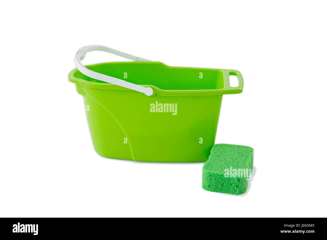 Closeup of green bucket with cleaning sponge against white background