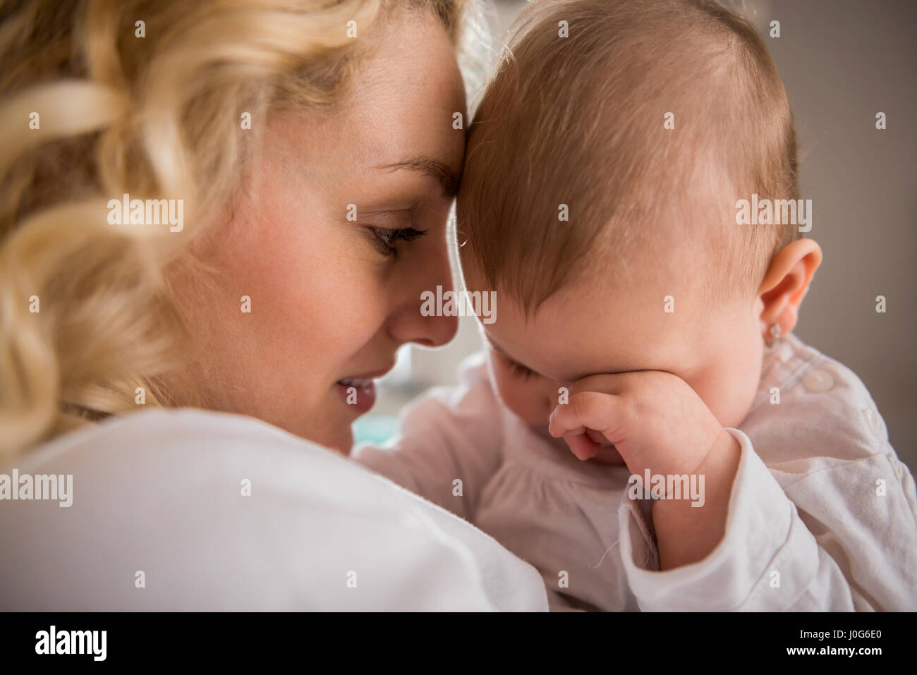 Mother holding sleeping baby in her arms Stock Photo Alamy