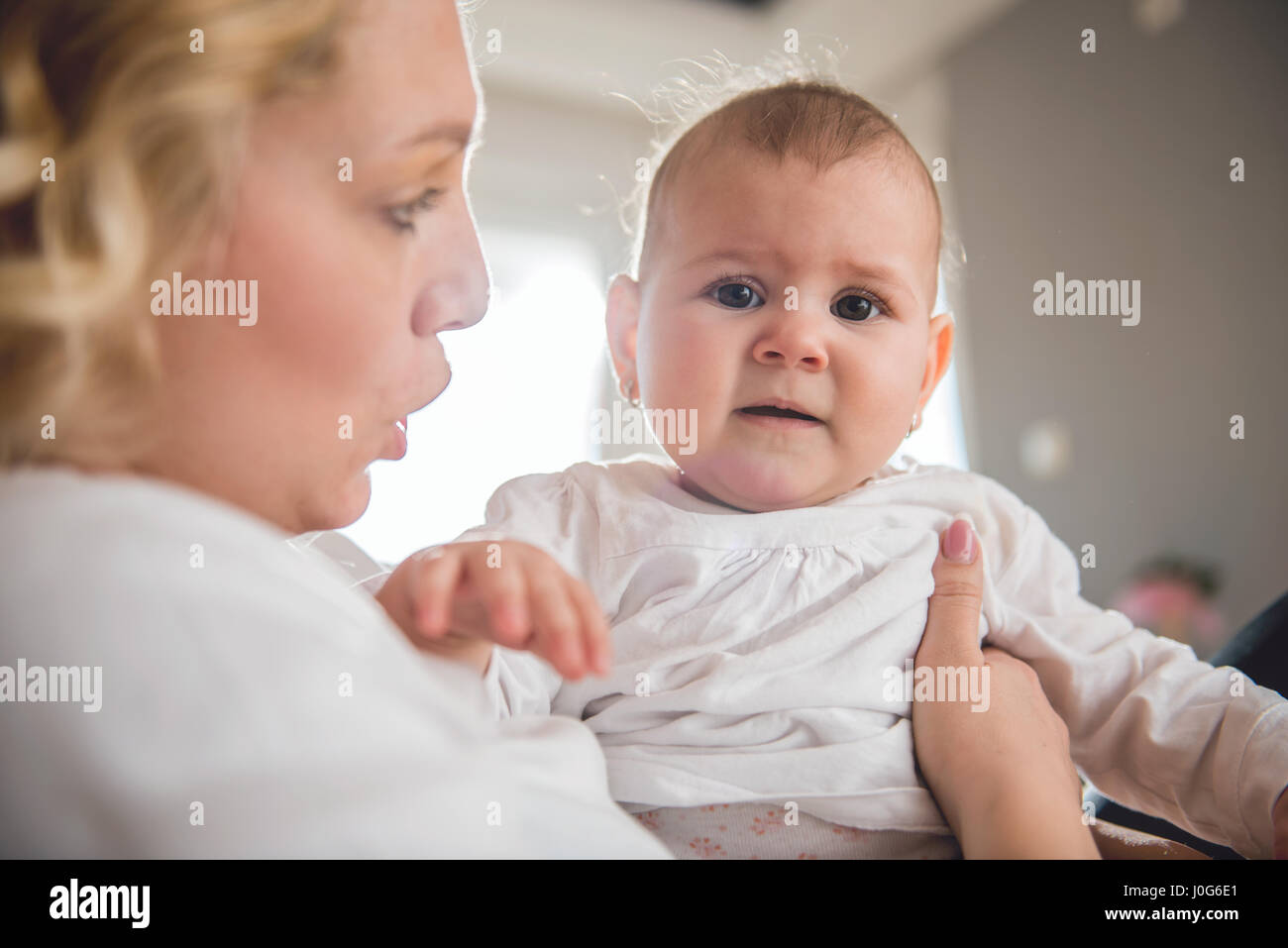 Mother holding her crying baby Stock Photo