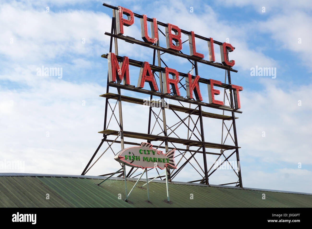 SEATTLE, WASHINGTON, USA - JAN 24th, 2017: Neon public market sign against cloudy sky, Pikes Place Market in downtown is a famous sight. Stock Photo