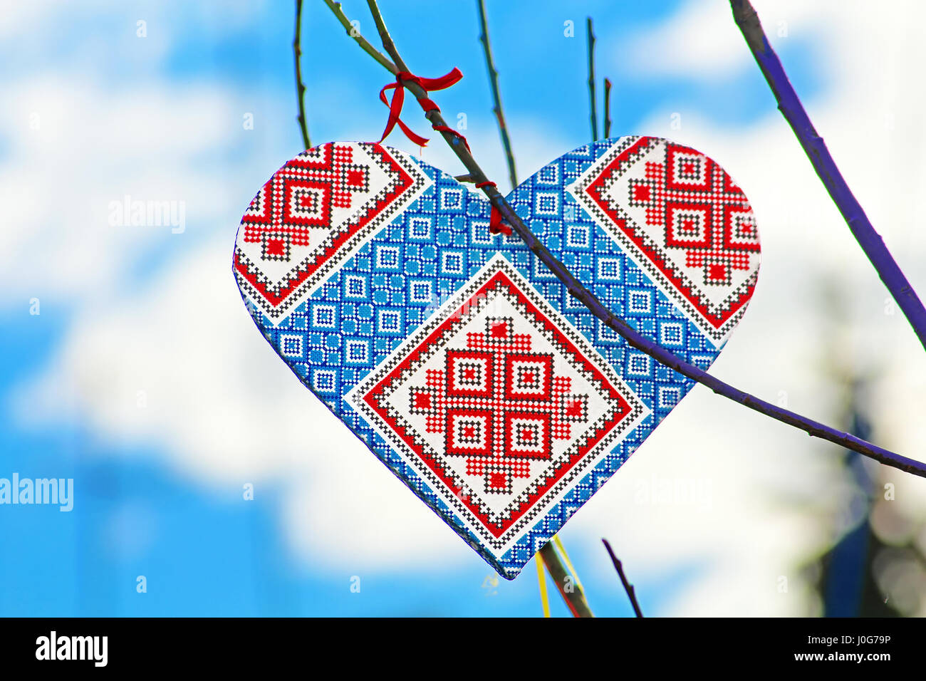 Hand made heart in the style of Ukrainian vyshyvanka on the handmade tree which children made due to Europe Day in Vinnytsia, Ukraine Stock Photo