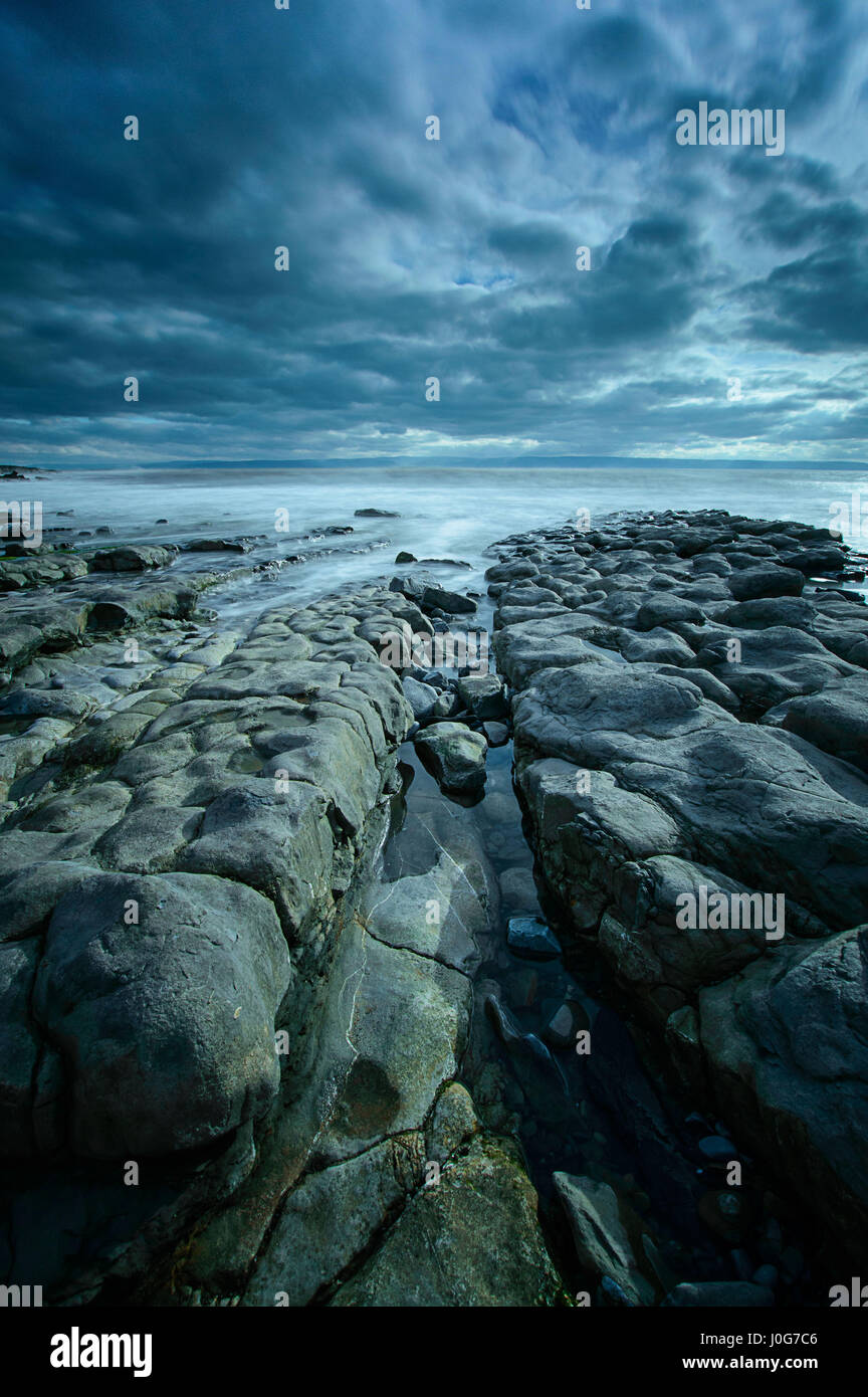A channel in between the rocks leading to the sea at Nash Point, on the ...