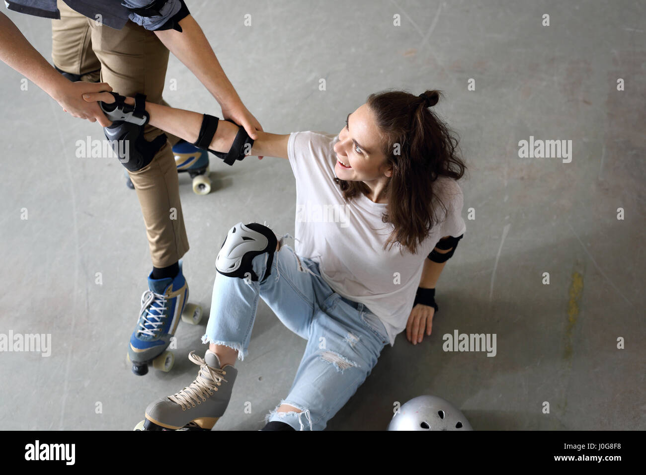 Roller skates. Woman on roller skates. Rollerskating Helmet, head protection. Young people