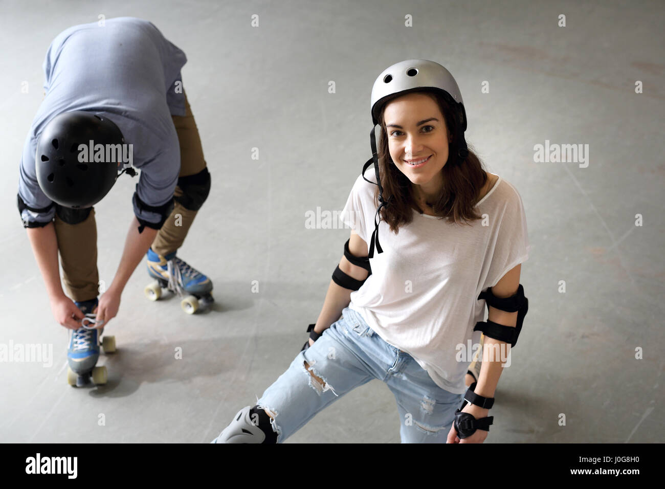 Roller skates. Woman on roller skates. Rollerskating Helmet, head  protection. Young people riding on roller skates Pads and knee pads Stock  Photo - Alamy