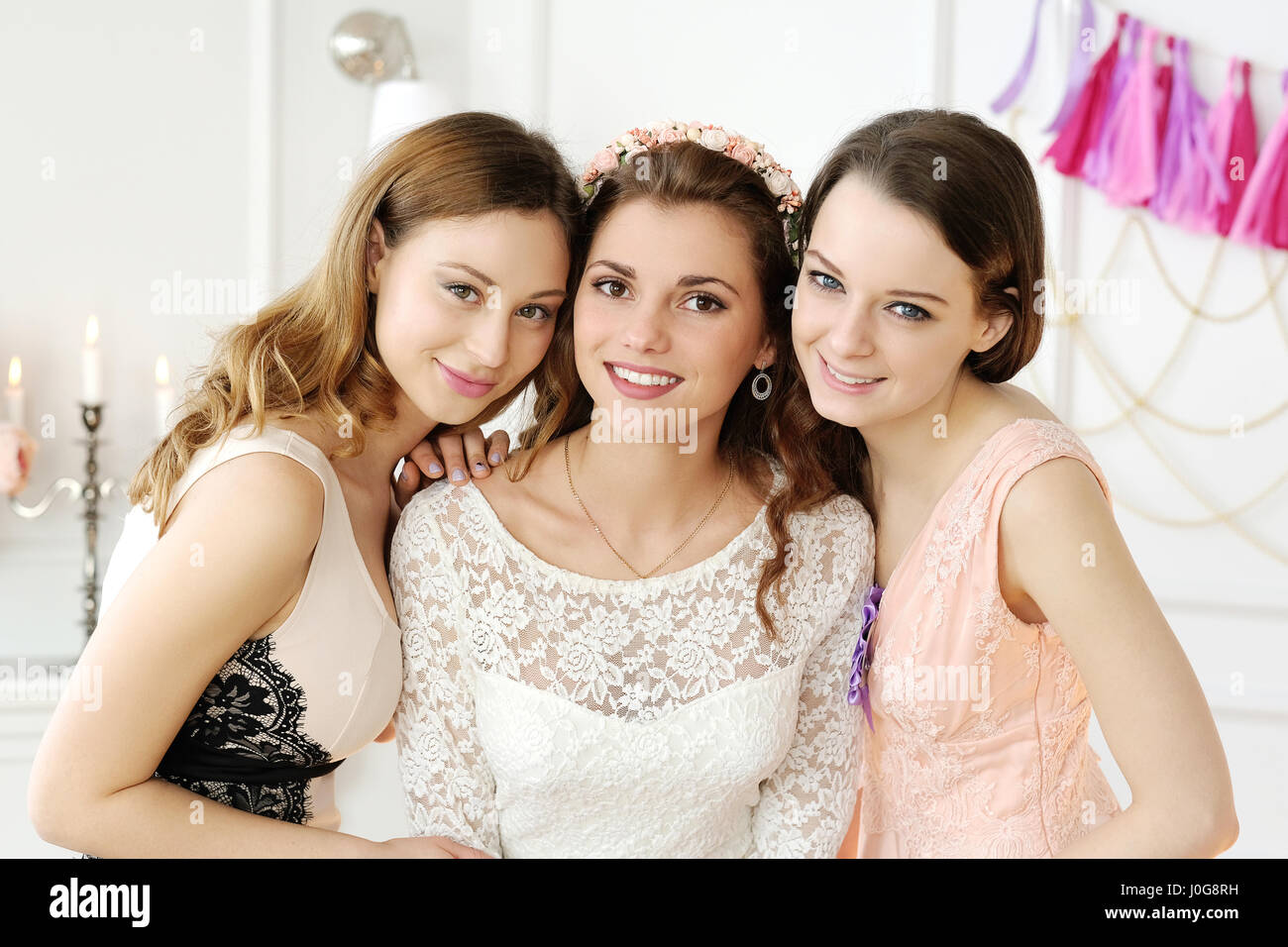 Three women in summer clothes have a lot of fun on a birthday party,  picture isolated on pink background Stock Photo - Alamy
