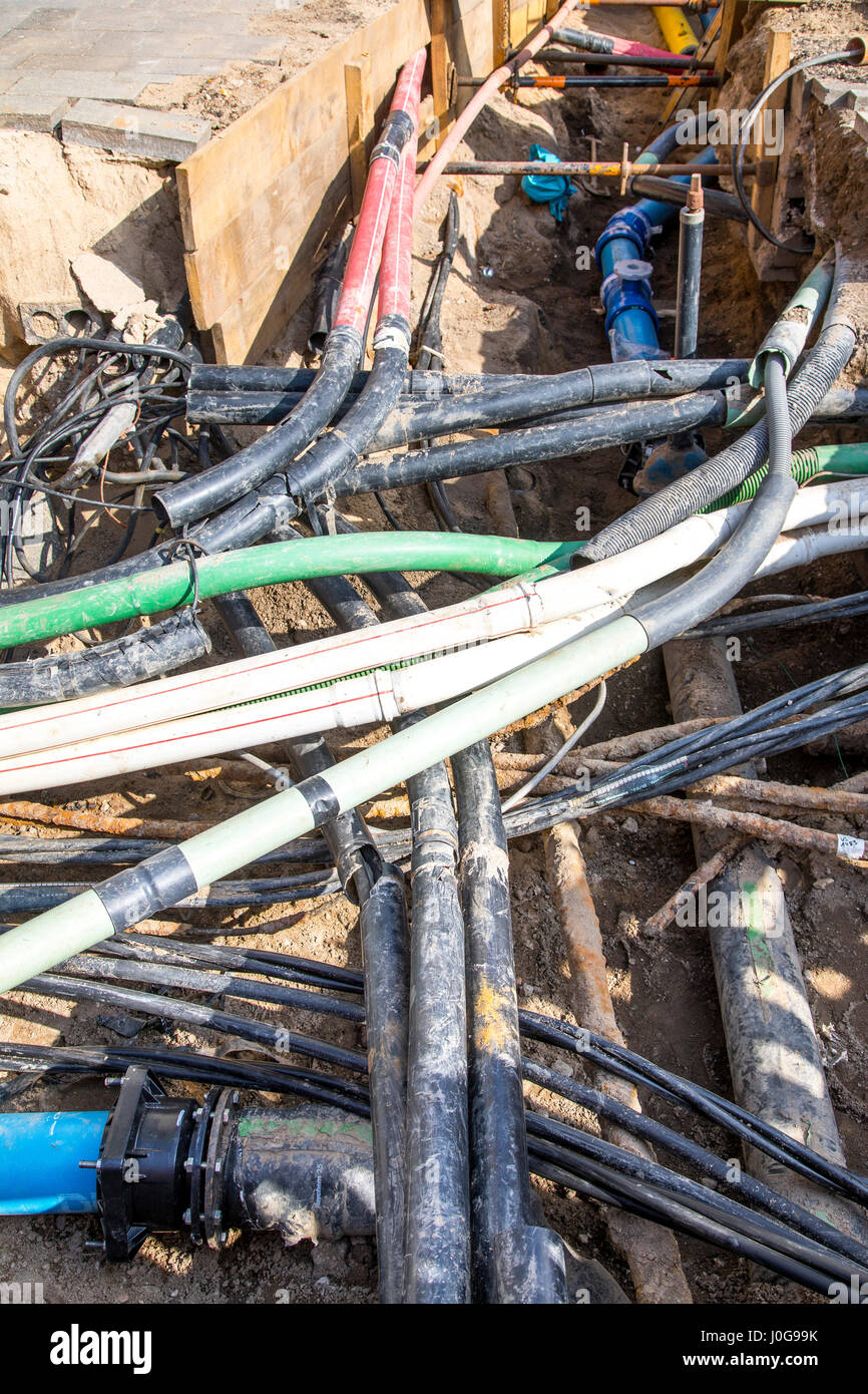 Cables, pipelines, tangle in a construction site, supply lines cleared ...