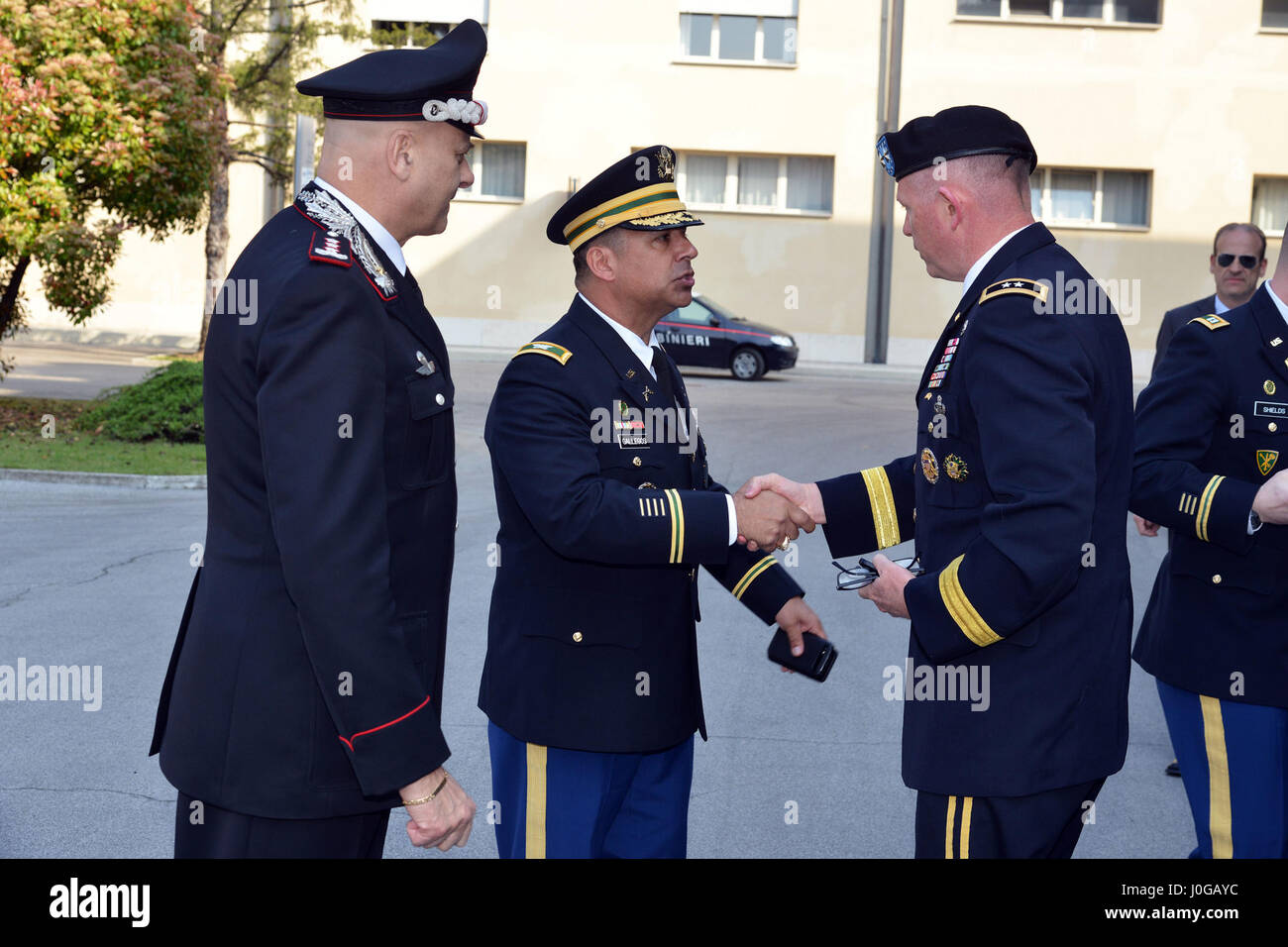 U.S. Army Col. Darius S. Gallegos (center), Center of Excellence for Stability Police Units (CoESPU) deputy director, Lt. Gen Vincenzo Coppola (left), Commanding General “Palidoro” Carabinieri Specialized and Mobile Units, welcome Maj. Gen. Joseph P. Harrington, U.S. Army Africa Commanding General, during the visit NATO JFC-Naples Commander, Admiral Michelle Howard at the CoESPU Vicenza, April 10, 2017. (U.S. Army Photo by Visual Information Specialist Paolo Bovo/released) Stock Photo