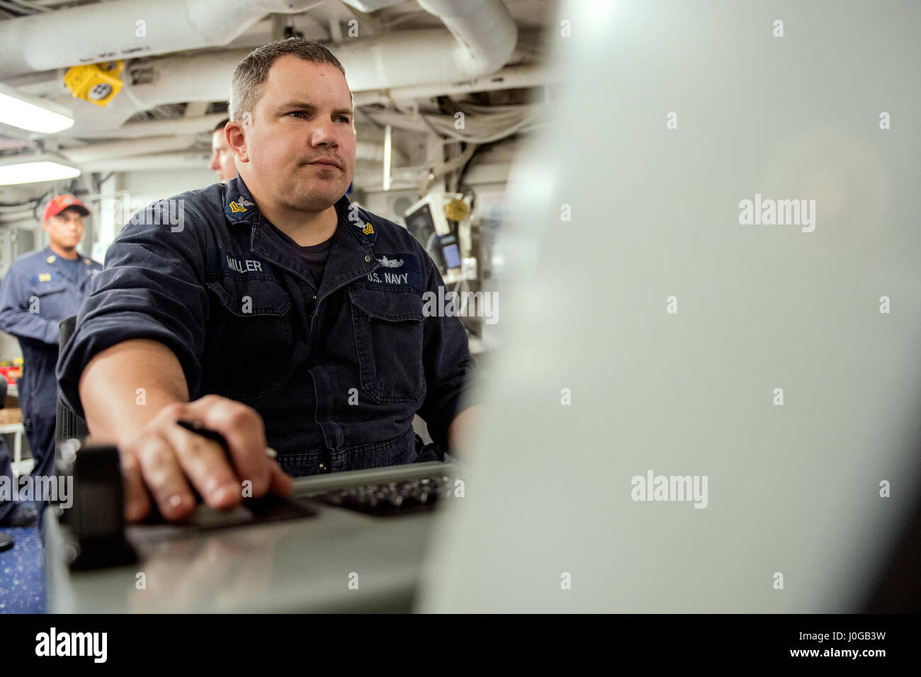 170410-N-FT178-014 SOUTH CHINA SEA (April 10, 2017) Damage Controlman 1st Class Randall Miller, from Aguanga, California, mans the electronic plant control console during an engineering drill aboard Ticonderoga-class guided-missile cruiser USS Lake Champlain (CG 57). Lake Champlain is on a regularly scheduled Western Pacific deployment with the Carl Vinson Carrier Strike Group as part of the U.S. Pacific Fleet-led initiative to extend the command and control functions of the U.S. 3rd Fleet in the Indo-Asia-Pacific region. Navy aircraft carrier strike groups have patrolled the Indo-Asia-Pacific Stock Photo