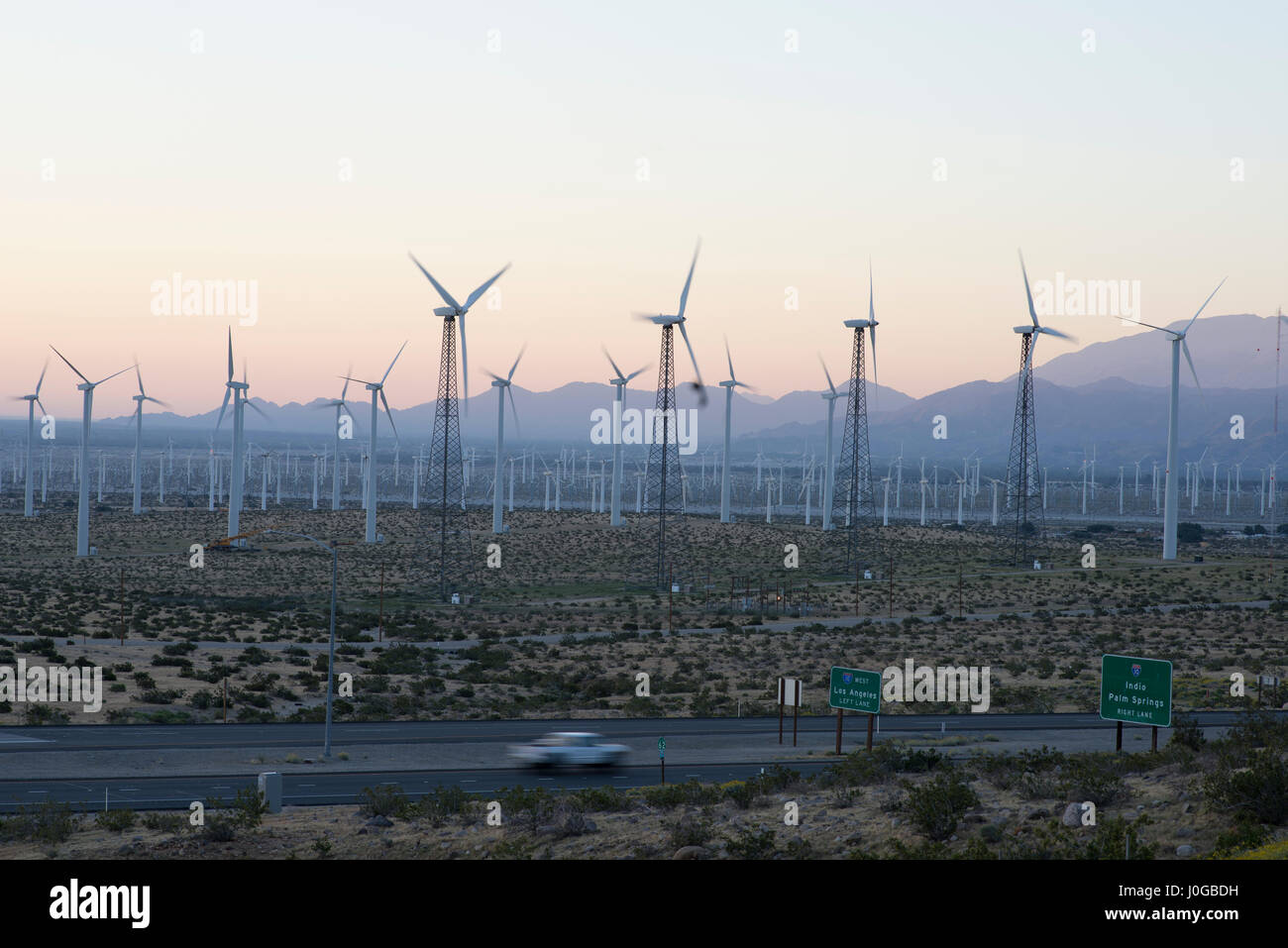 Wind turbines at the San Gorgonio Pass Wind Farm, Southern California, USA. Highway 62 in the foreground. Stock Photo