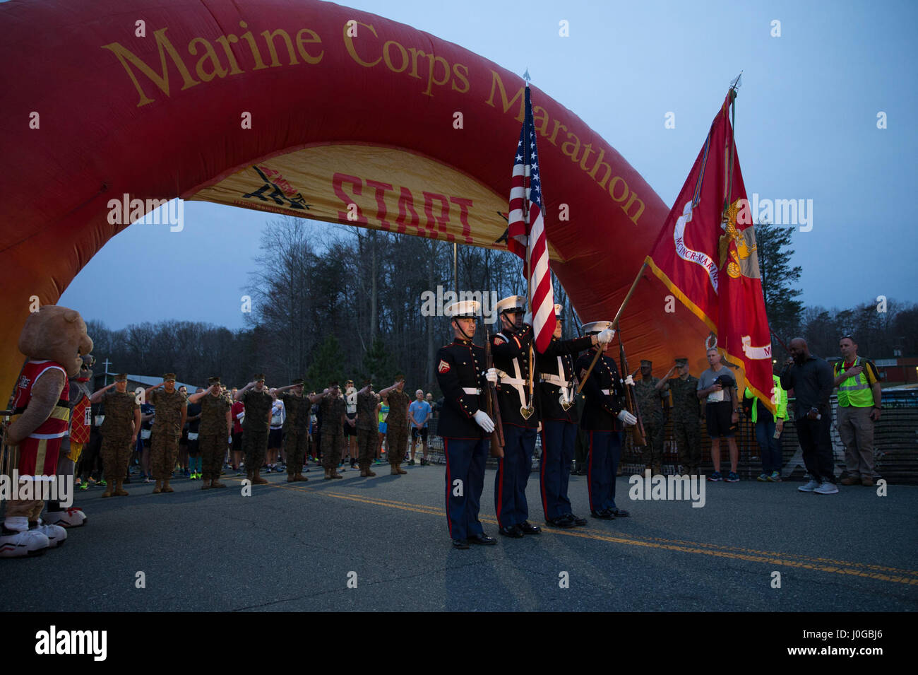 U.S. Marines with the Marine Corps Base Quantico Color Guard present the colors during the start of the Marine Corps Marathon (MCM) 17.75K at Prince William Forest Park, Va., March 25, 2017. The 17.75K distance commemorates the year the Marine Corps was established and offers guaranteed access to the MCM to the participants who finish in the allotted time. (U.S. Marine Corps photo by Lance Cpl. Cristian L. Ricardo) Stock Photo