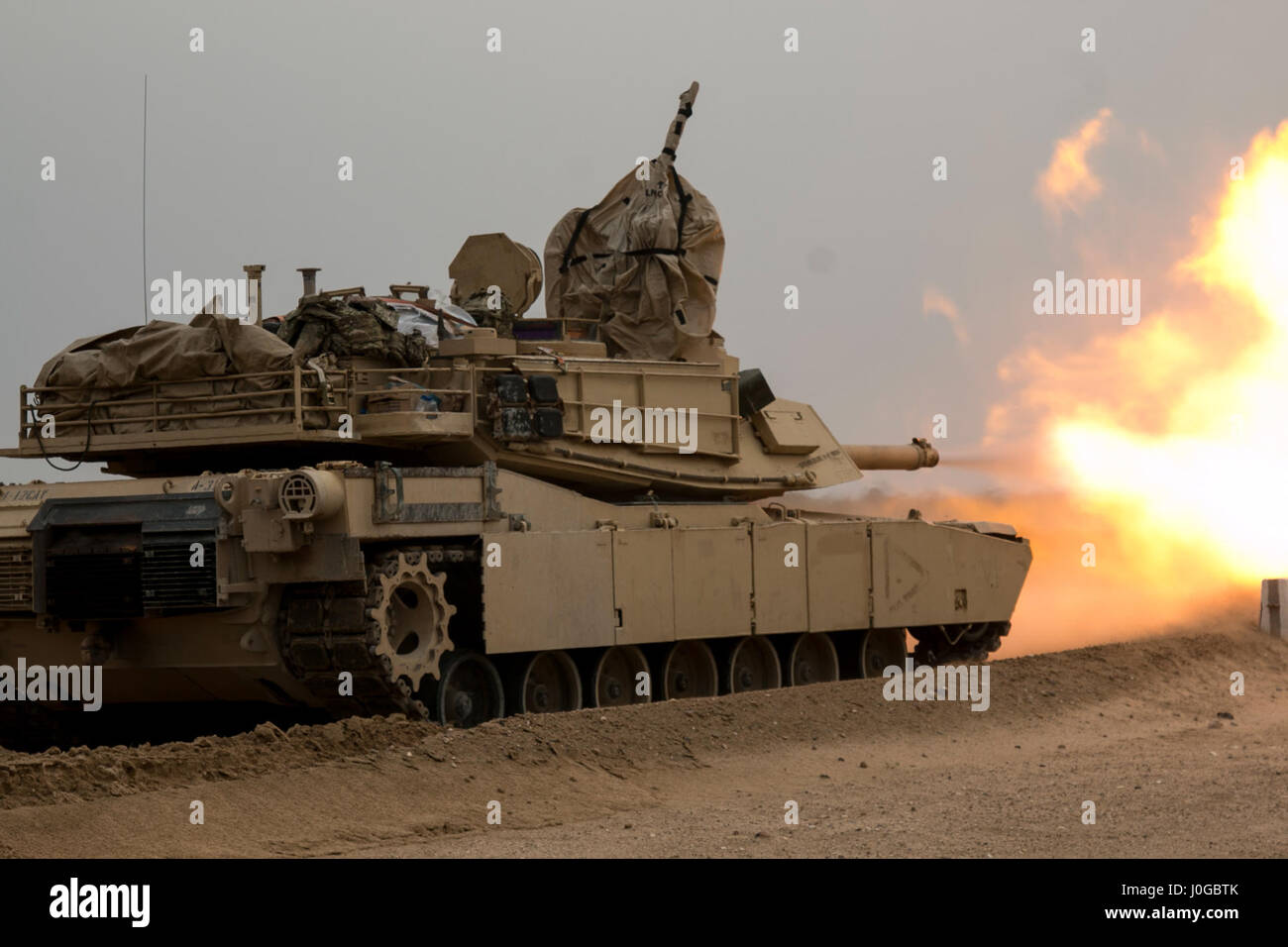 A 3rd Armored Brigade Combat Team, 1st Cavalry Division M1A2 Abrams Main Battle Tank engages targets during the brigade's Table VI qualifications at the Udairi Range Complex March 28. The brigade tank and Bradley crews spent about two weeks in the field conducting sustainment gunnery to ensure all the crews qualified at day and night fire to maintain proficiency. (U.S. Army photo by Staff Sgt. Leah R. Kilpatrick, 3rd Armored Brigade Combat Team Public Affairs Office, 1st Cavalry Division (released) Stock Photo