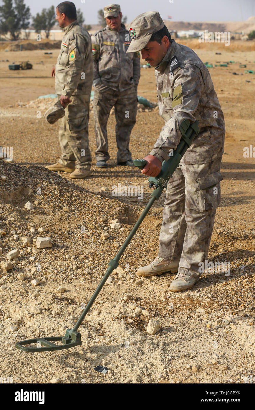 An Iraqi security forces soldier uses a metal detector to scan for an improvised explosive device during counter-IED training at Al Asad Air Base, Iraq, March 29, 2017. This training is part of the overall Combined Joint Task Force – Operation Inherent Resolve building partner capacity mission by training and improving the capability of partnered forces fighting ISIS. CJTF- OIR is the global Coalition to defeat ISIS in Iraq and Syria. (U.S. Army photo by Sgt. Lisa Soy) Stock Photo