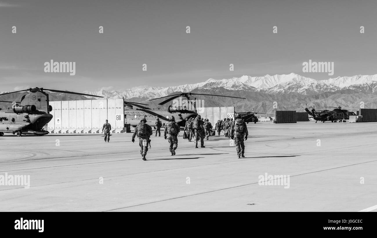 U.S. Army Soldiers assigned to 1st Squadron, 14th Cavalry Regiment, 1st Stryker Brigade Combat Team, 2nd Infantry Division exit a CH-47 Chinook helicopter assigned to Task Force Flying Dragon, 16th Combat Aviation Brigade, 7th Infantry Division during training at Bagram Airfield, Afghanistan, April 1, 2017. The Cavalry troopers provide a ready response force for downed aircraft, and the training focused on preparing them to assume their mission in support of Operation Freedom’s Sentinel and Resolute Support Mission. Stock Photo