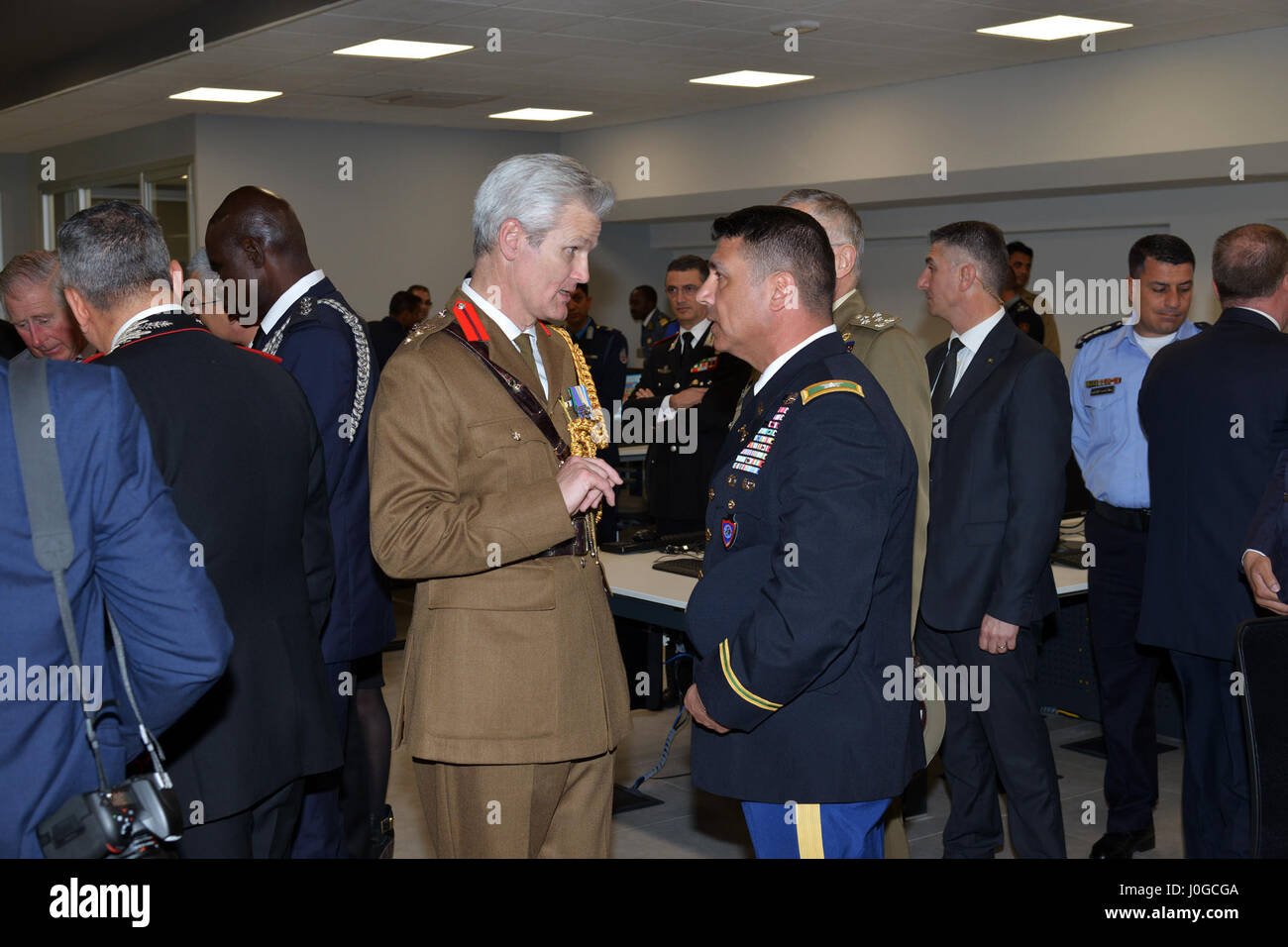 U.S. Army Col. Darius S. Gallegos, CoESPU deputy director (right) speaks with British officer during visit at Center of Excellence for Stability Police Units (CoESPU) Vicenza, Italy, April 1, 2017. (U.S. Army Photo by Visual Information Specialist Antonio Bedin/released) Stock Photo