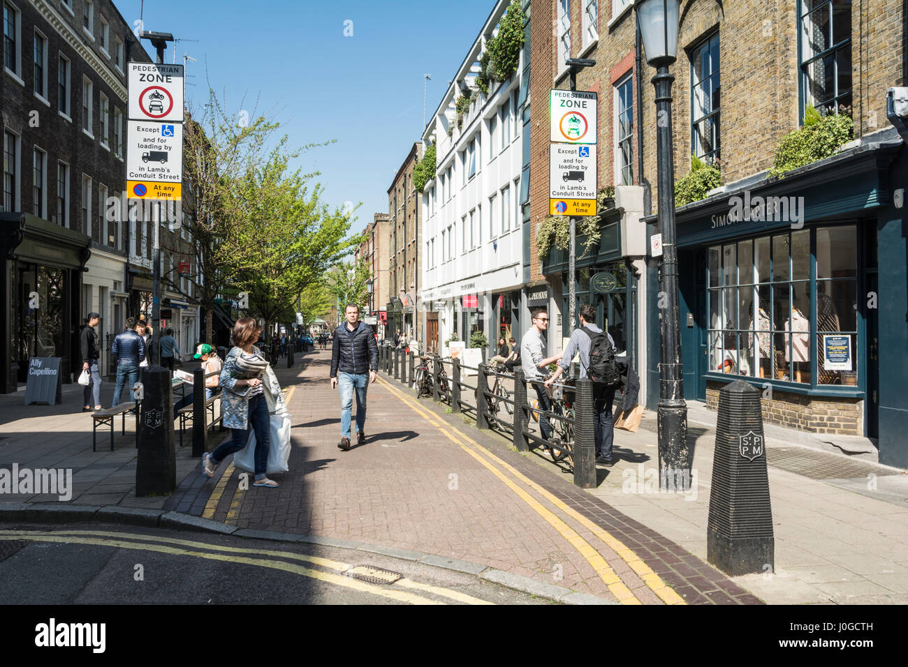 Shops and shoppers on Lamb's Conduit Street in Bloomsbury, London, UK