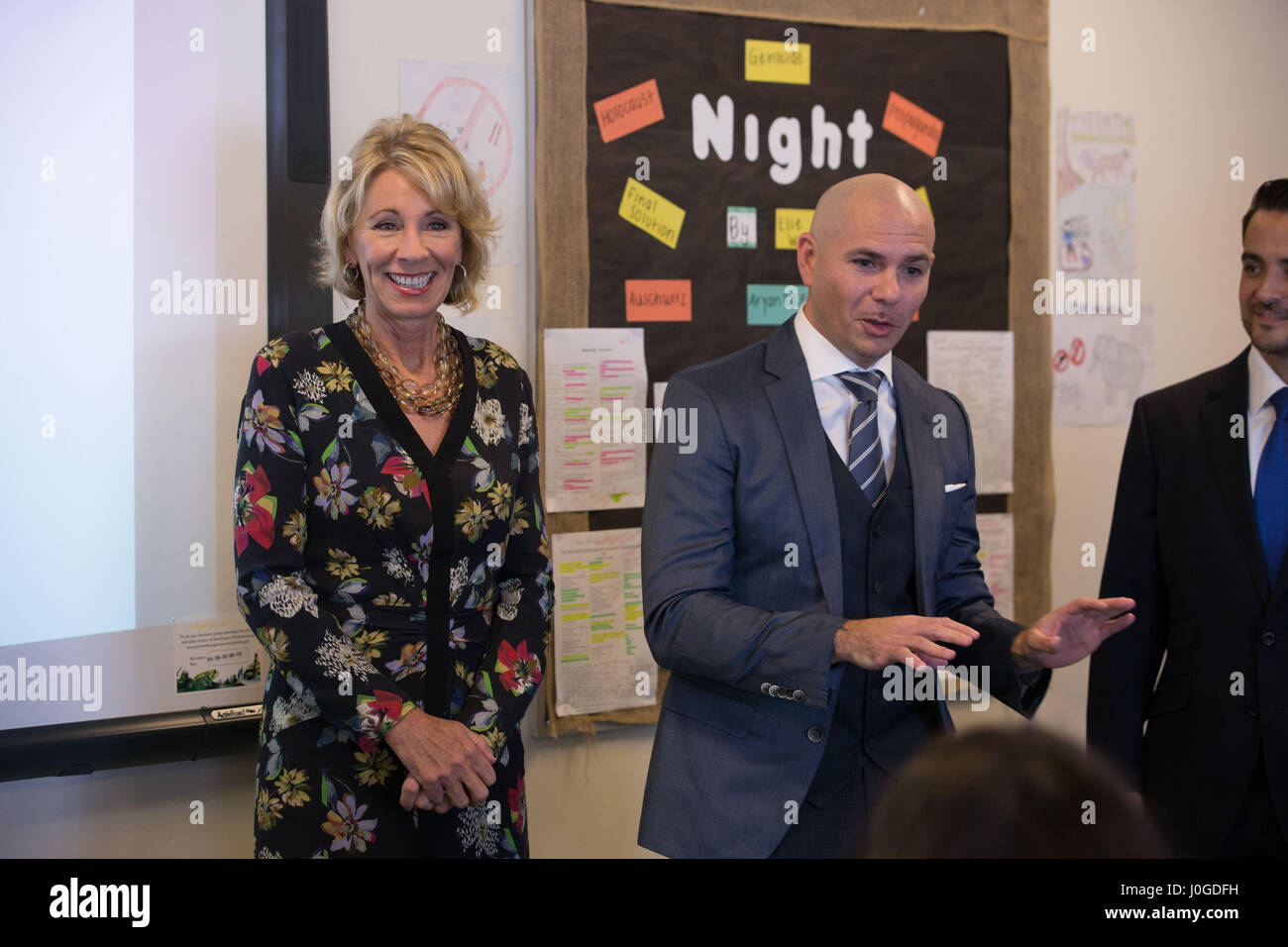 U.S. Secretary of Education Betsy DeVos, left, during a classroom visit with with the rapper Pitbull at the SLAM  charter school he supports in Little Havana April 6, 2017 in Miami, Florida. The controversial education secretary made several stops including her first visit to a public university, a private christian school and the charter school. Stock Photo