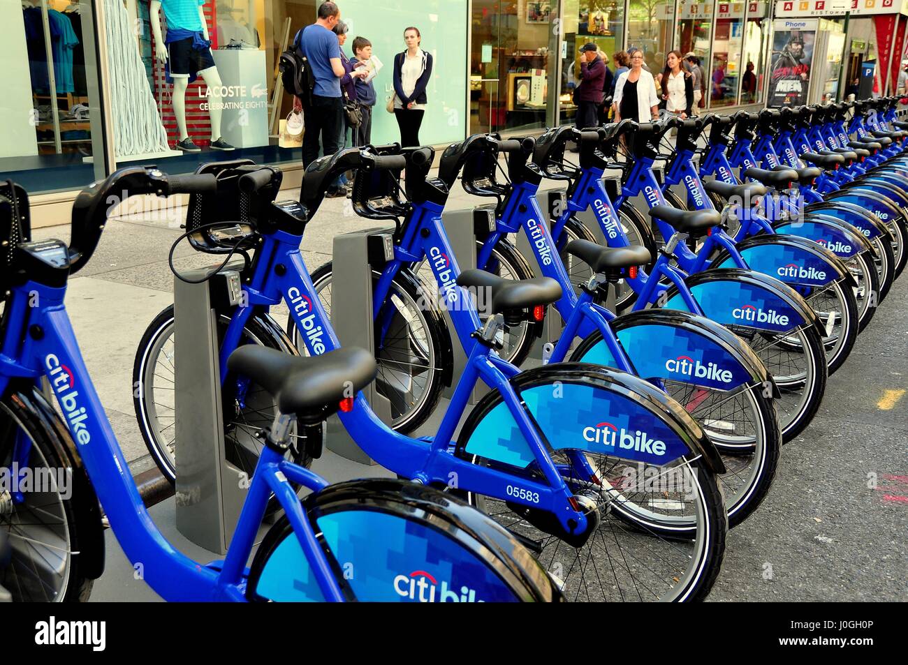 New York, NY - May 27, 2013:  Rows of Citibike rental blue bicycles emblazoned with the Citibank logo sit at a West 49th Street docking Stock Photo