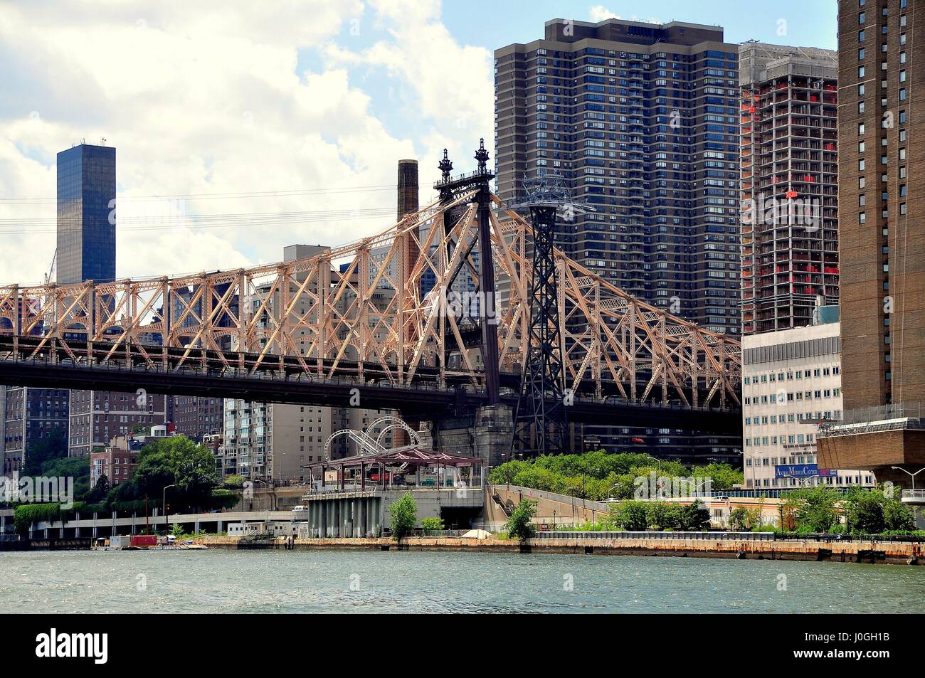 New York City - August 1, 2013:  Queensboro (59th Street) Bridge over the East River and Roosevelt Island tram tower Stock Photo