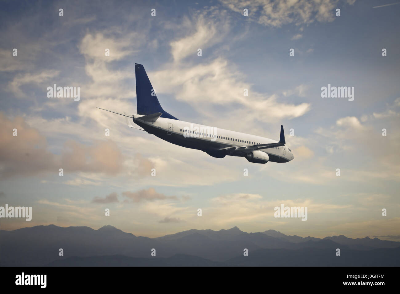 Airplane flying in the sky Stock Photo - Alamy