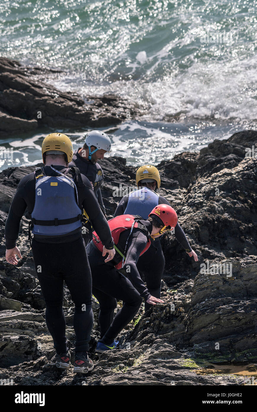 Coasteering Adventure Rocks Sea Intertidal zone Rugged Adventure Physical activity Physical effort Coast Coastal Tourism Climbing Newquay Cornwall Stock Photo