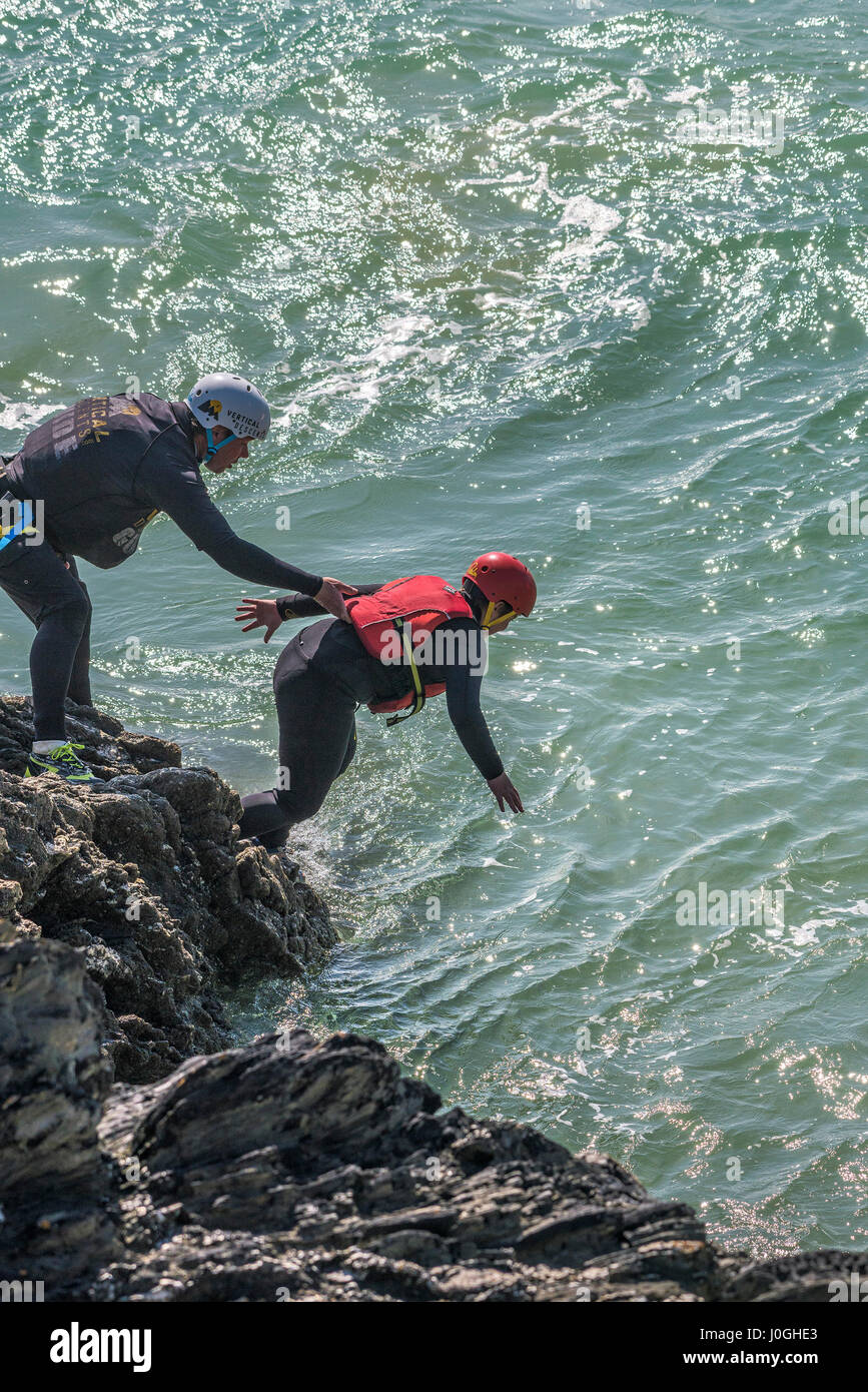 Coasteering Adventure Rocks Sea Intertidal zone Rugged Adventure Physical activity Physical effort Coast Coastal Tourism Newquay Cornwall Stock Photo