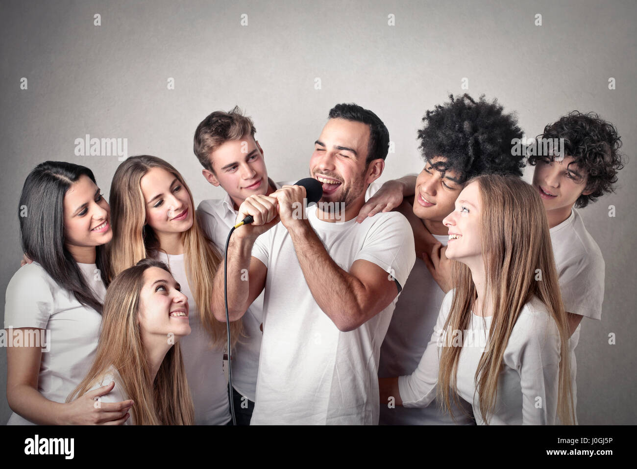 Man singing with friends Stock Photo