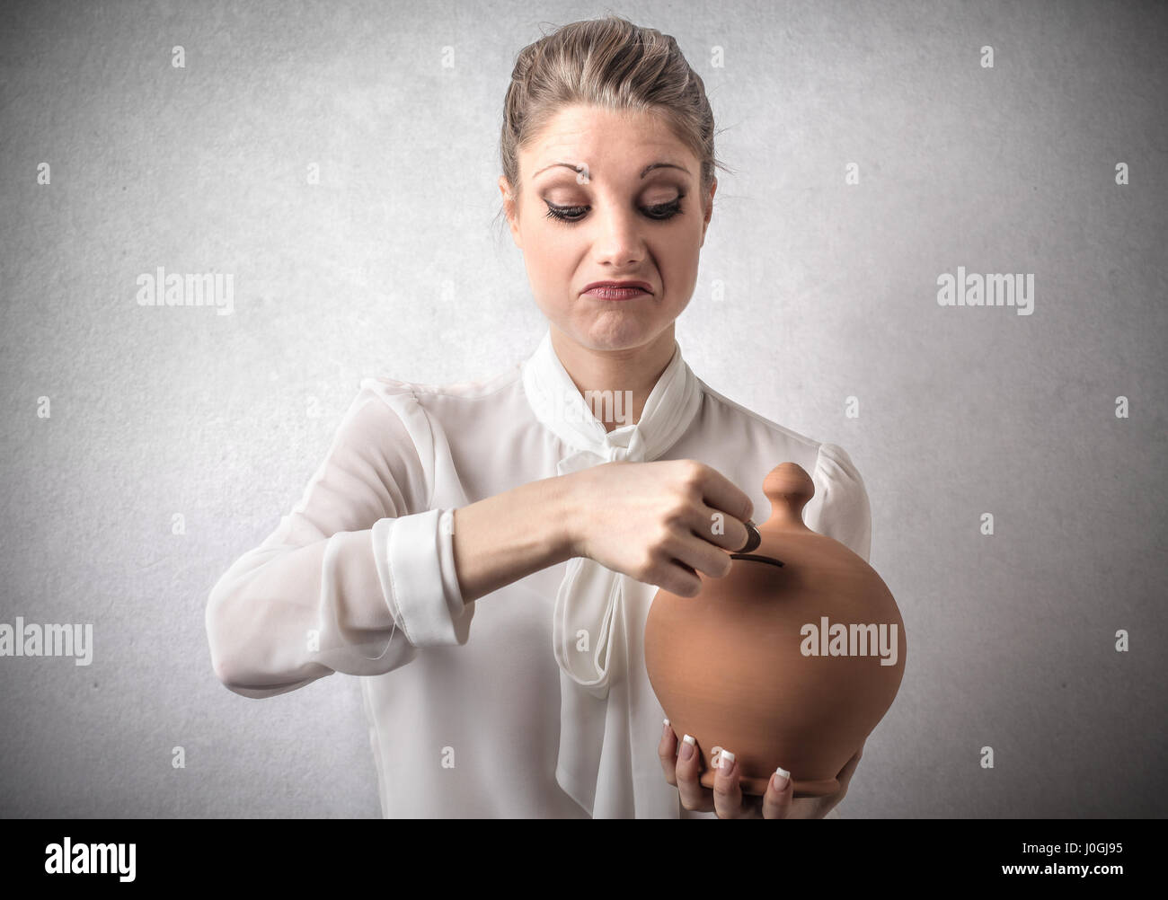 Blond woman with piggy bank Stock Photo
