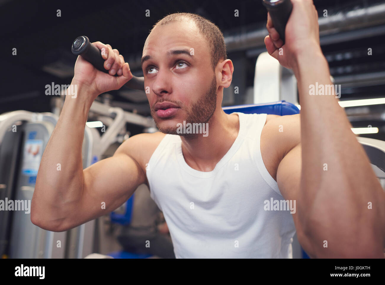 Man doing training with exercise machine Stock Photo - Alamy