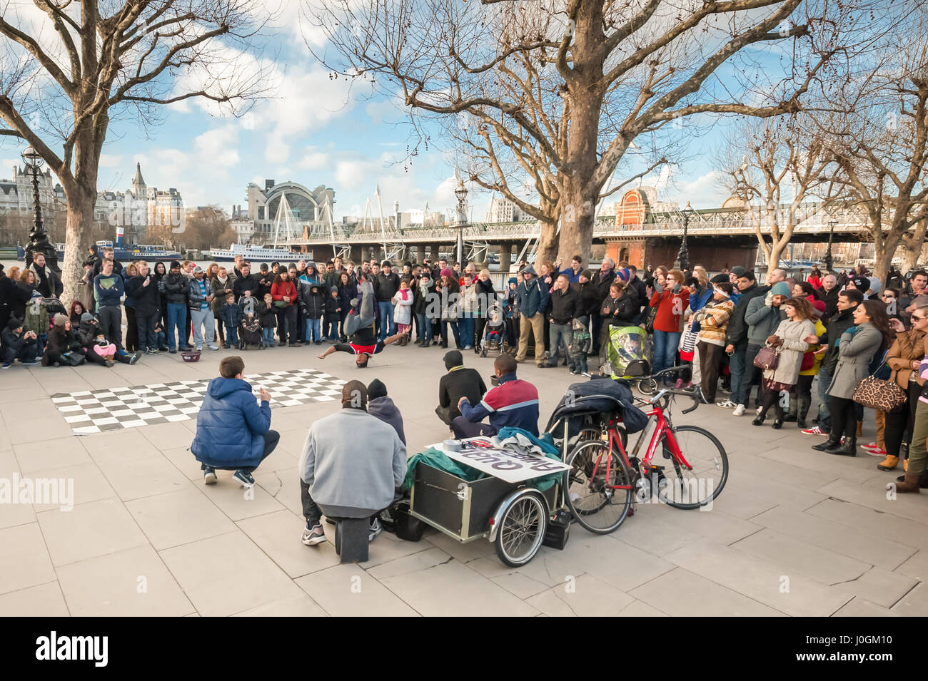 London, UK - January 27, 2013: A large crowd watching street dance performers on a cold afternoon by the South Bank of River Thames in London, UK Stock Photo