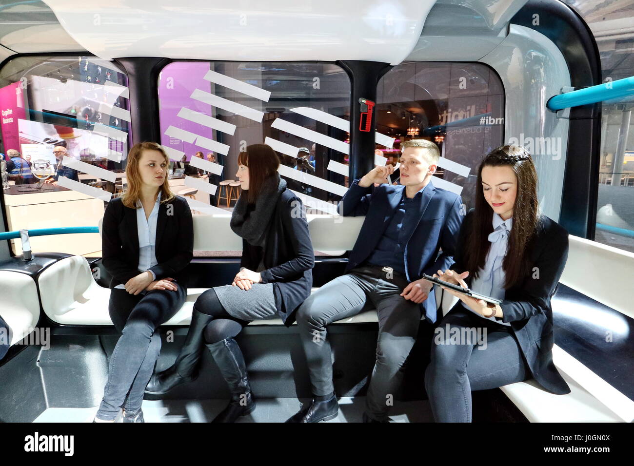 Hanover, Germany. 19th March, 2017. Passengers in self-driving electric minibus 'Olli', developed by Local Motors in cooperation with IBM. IBM-System Watson IoT (Internet of Things) controls the autonomous driving. CeBIT 2017, ICT trade fair, lead theme 'd!conomy - no limits'. Photocredit: Christian Lademann Stock Photo