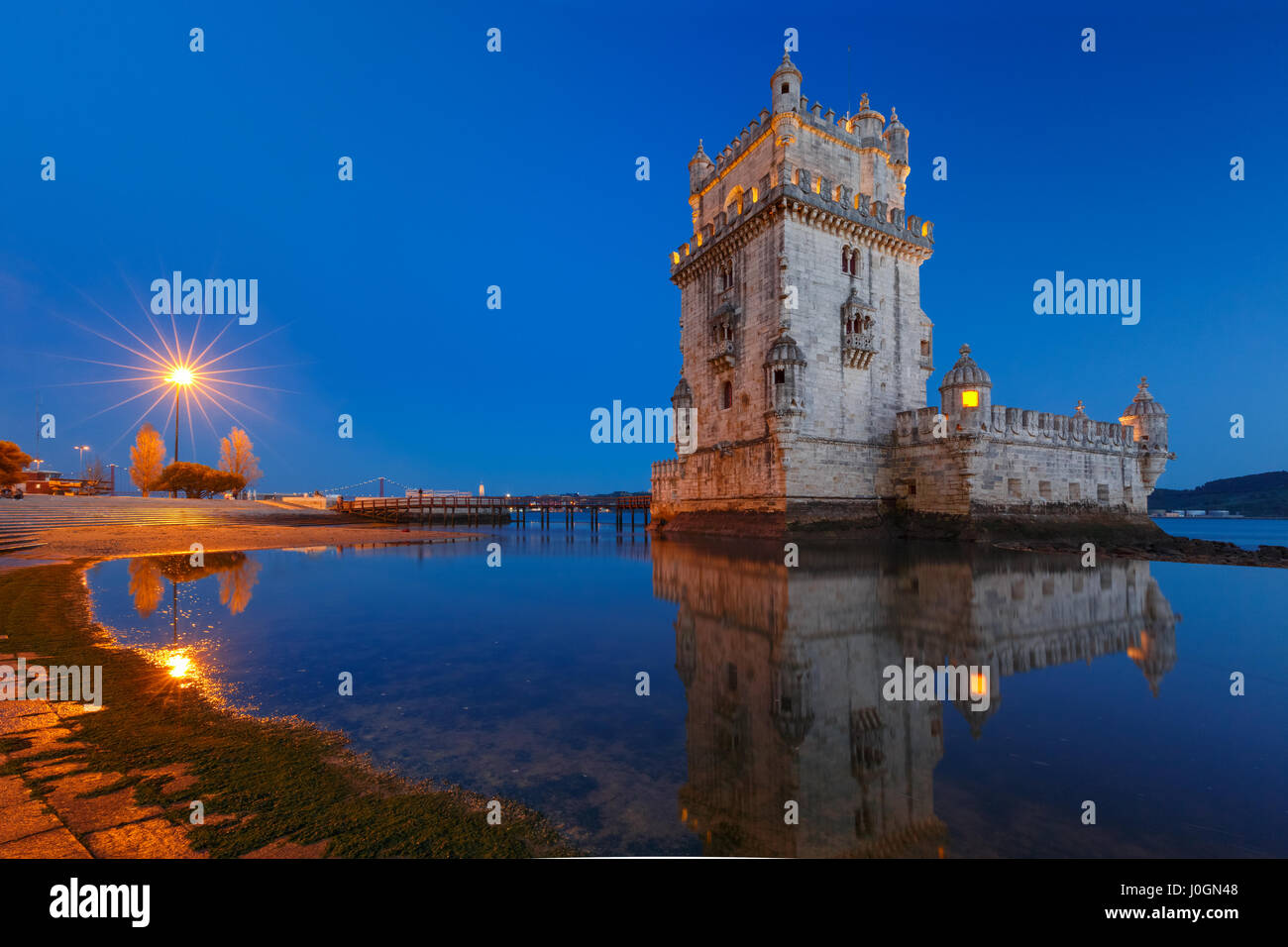 Belem Tower or Tower of St Vincent on the bank of the Tagus River during evening blue hour, Lisbon, Portugal Stock Photo