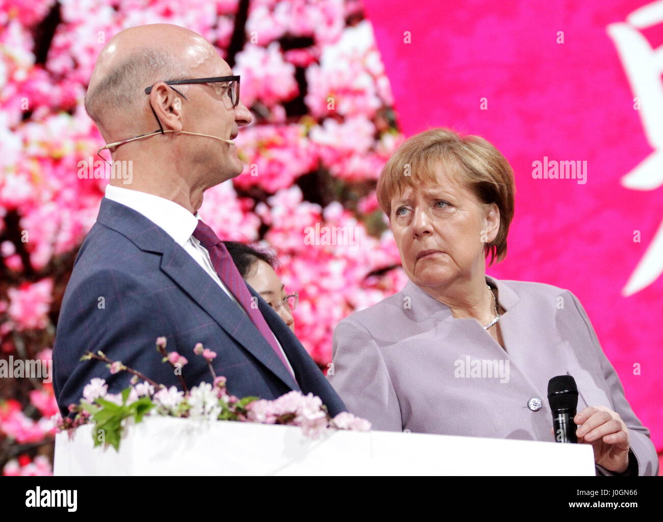 Hanover, Germany. 20th March, 2017. Timotheus Höttges (left), CEO Deutsche Telekom AG, meets Angela Merkel, Federal Cancellor of Germany, at Telekom's exhibition stand, CeBIT-opening walk, CeBIT 2017, ICT trade fair, lead theme 'd!conomy - no limits'. Photocredit: Christian Lademann Stock Photo