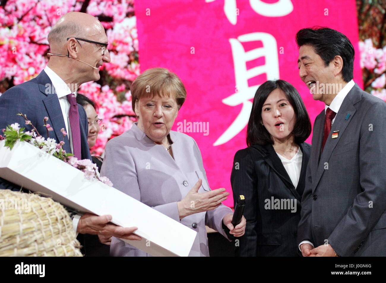 Hanover, Germany. 20th March, 2017. Timotheus Höttges (left), CEO Deutsche Telekom AG, meets Angela Merkel, Federal Cancellor of Germany, and Shinzo Abe, Prime Minister of Japan, at Telekom's exhibition stand, CeBIT-opening walk, CeBIT 2017, ICT trade fair, lead theme 'd!conomy - no limits'. Photocredit: Christian Lademann Stock Photo