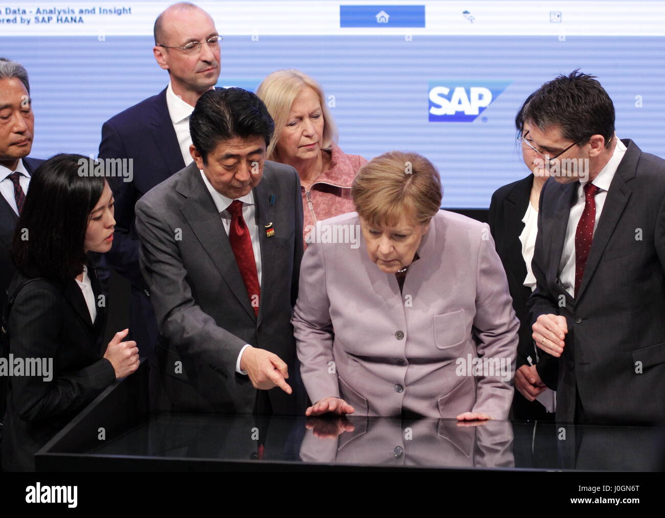 Hanover, Germany. 20th March, 2017. Shinzo Abe (Prime Minister of Japan) and Angela Merkel (Federal Cancellor of Germany) meet Bernd Leukert (right, Executive Board SAP SE, Products and Innovations) at SAP's exhibition stand, CeBIT-opening walk, CeBIT 2017, ICT trade fair, lead theme 'd!conomy - no limits'. Photocredit: Christian Lademann Stock Photo