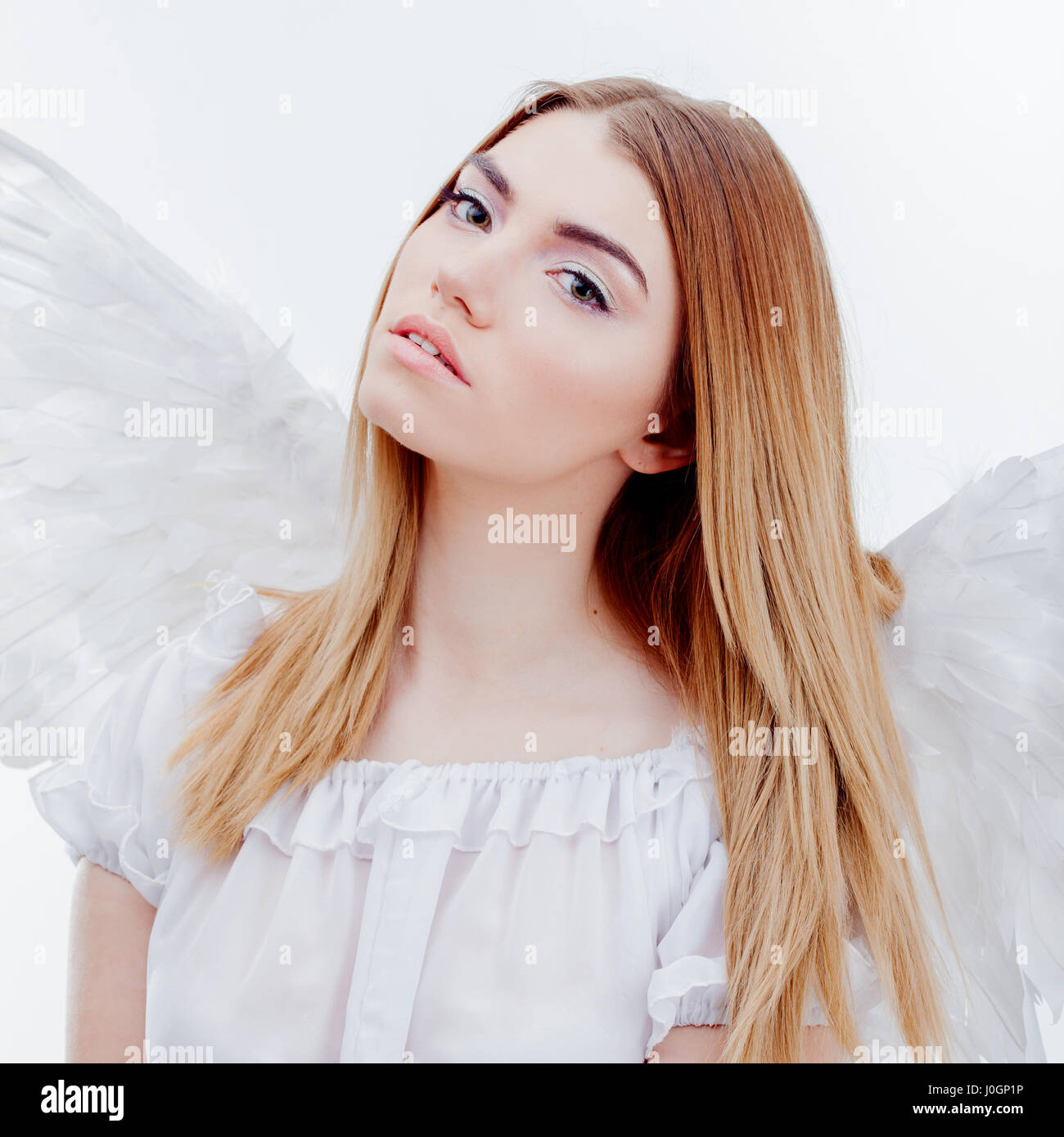 Young and wonderful blonde girl in the image of an angel with white ...