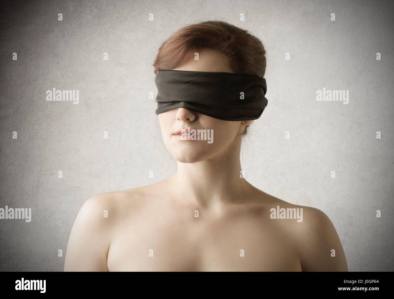 Woman being blindfolded Stock Photo