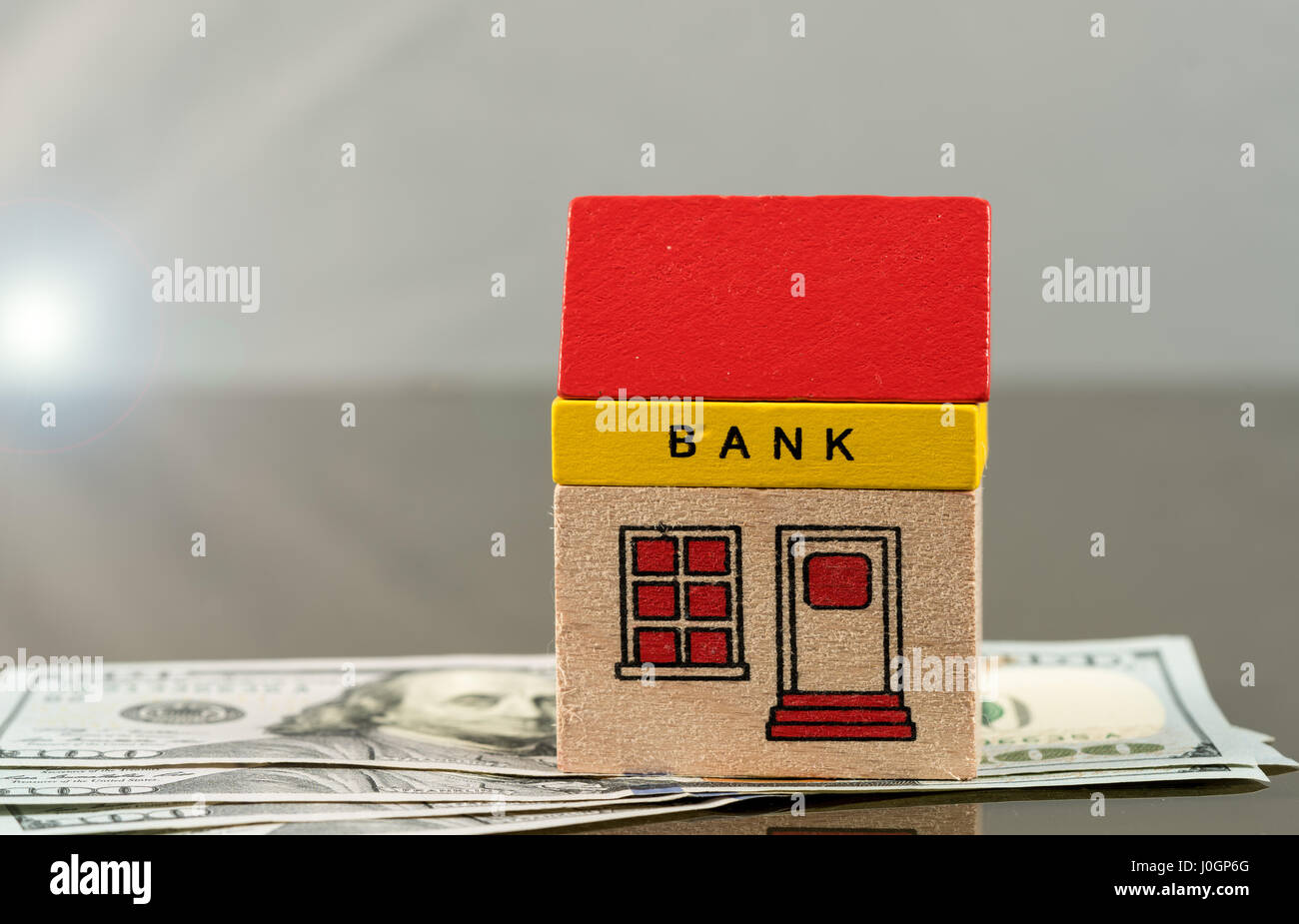 Toy bank building on US dollar assets Stock Photo