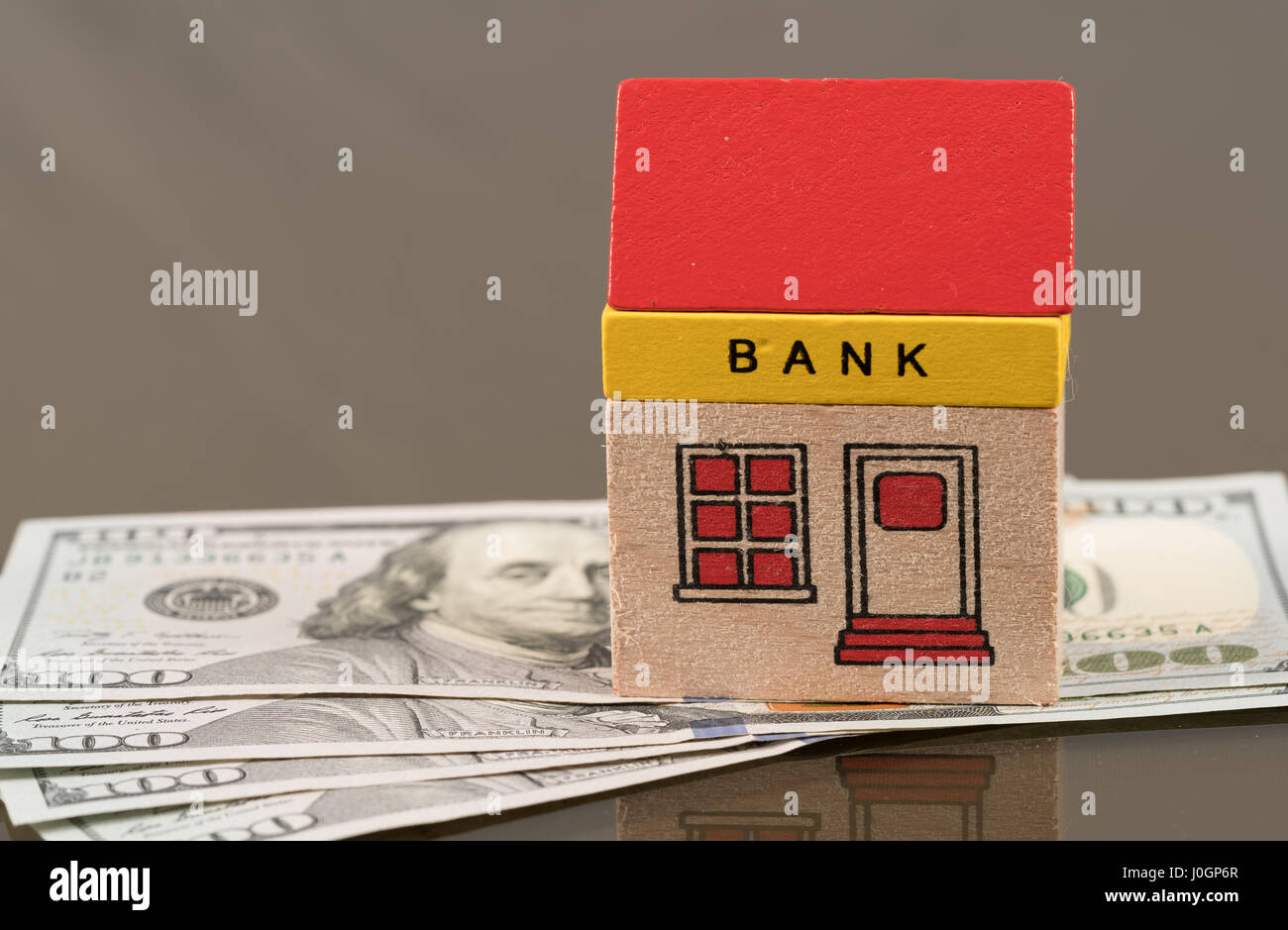 Toy bank building on US dollar assets Stock Photo