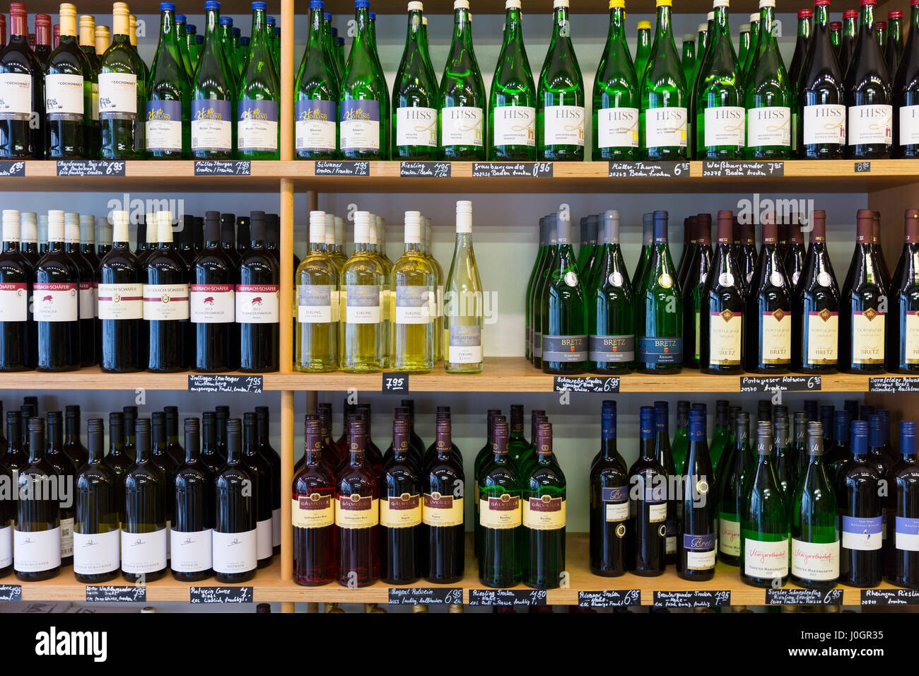 Shelves of bottles of German white and red wine on display in shop in