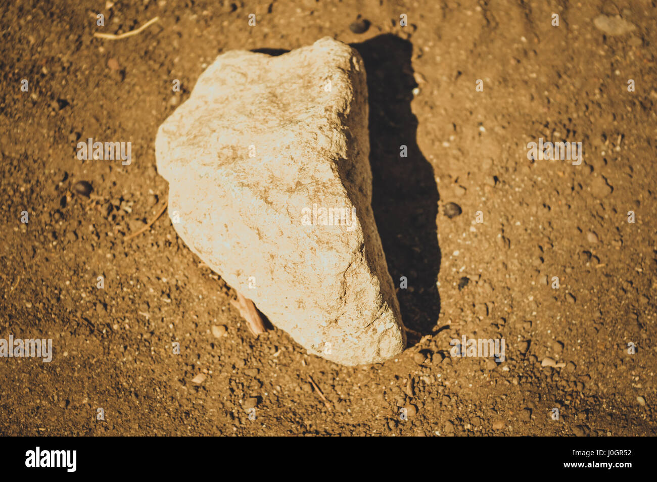 big stone on ground background Stock Photo - Alamy