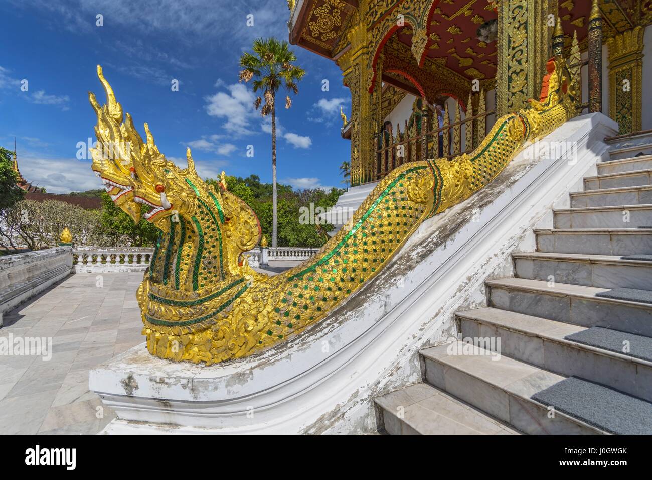 Golden naga (King Cobras) decorate teh stairs of Haw Pha Bang (or Palace Chapel) at the Royal Palace Museum in Luang Prabang, Laos. Stock Photo