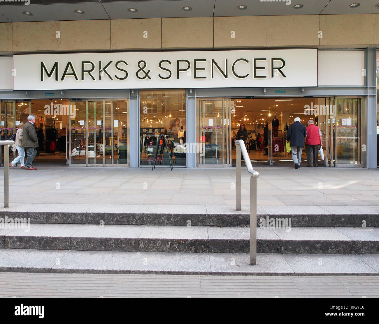 Exterior of the Manchester city centre shop shops Marks and Spencer, with mature male and female customers entering and leaving the shop. Stock Photo