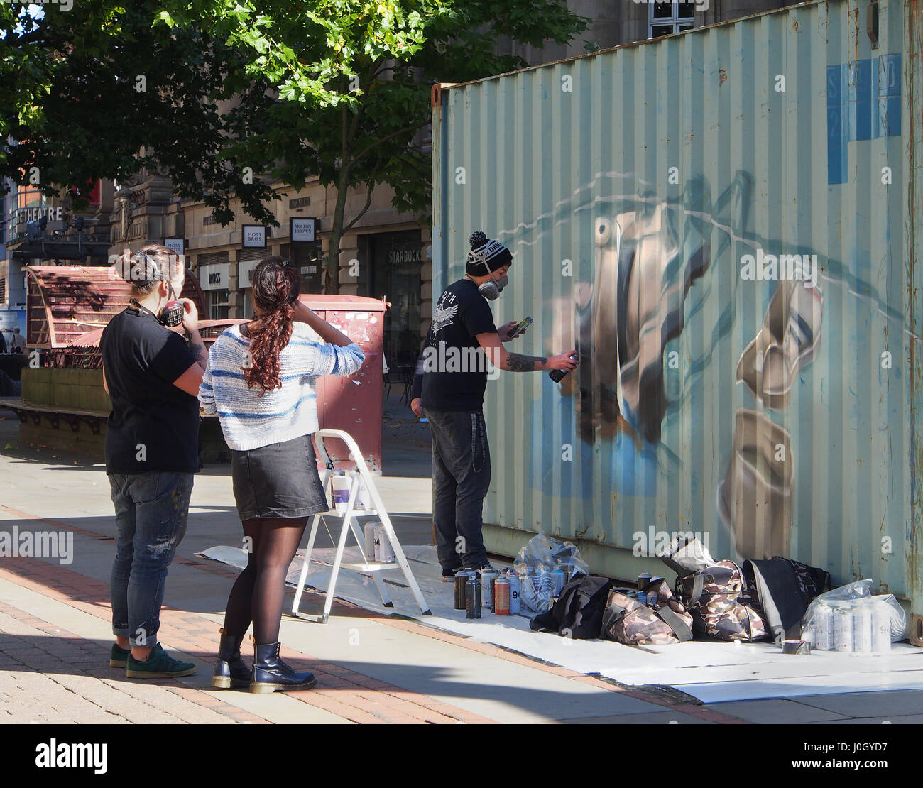 Legal graffitti, grafitti, graffiti, a young man gives a demonstration of painting with spray paint on a container in St. Anne's Square in Manchester, Stock Photo