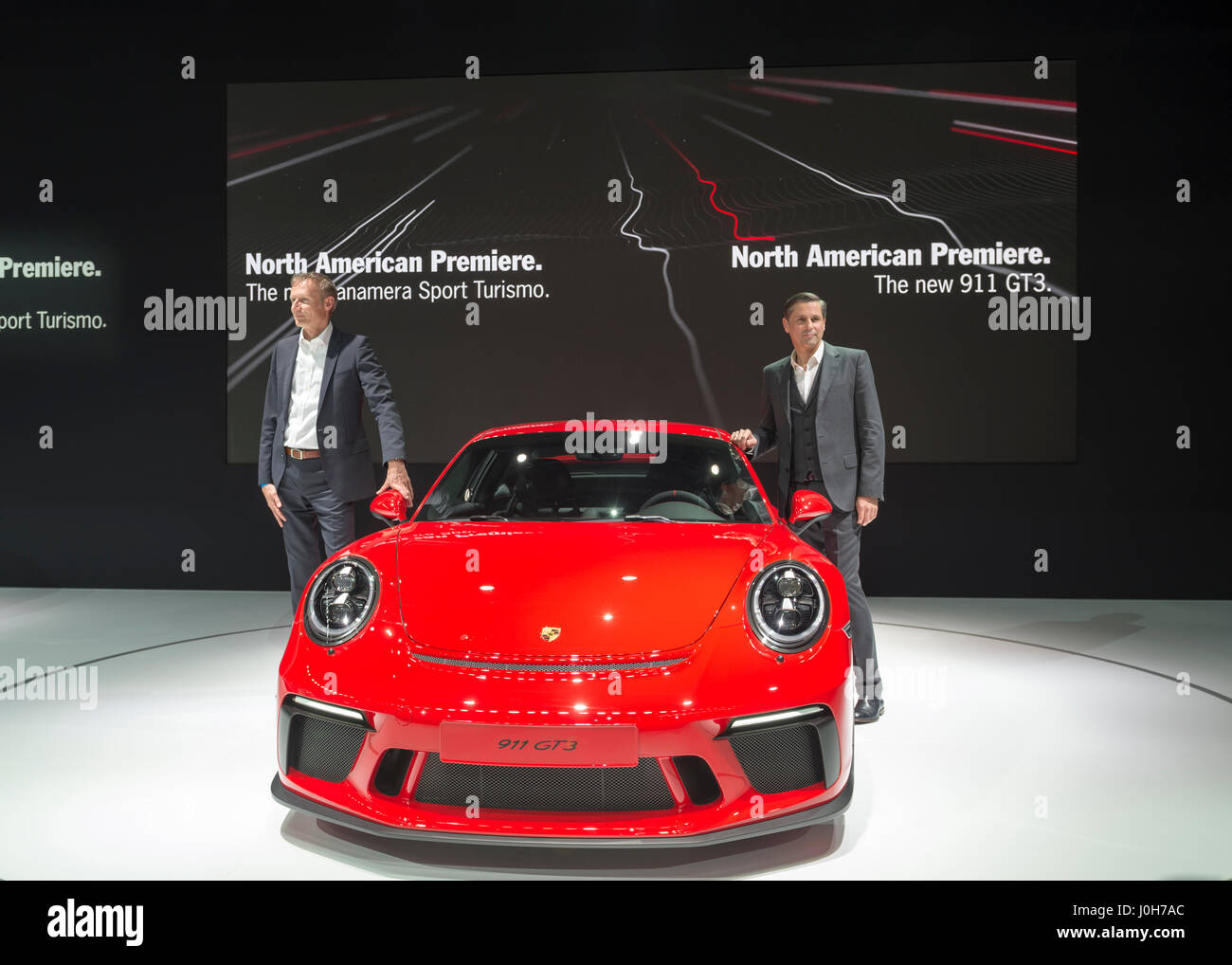 Manhattan, USA. 12th Apr, 2017. R-L, KLAUS ZELLMER, President and Chief Executive Officer of Porsche Cars North America, Inc, and ANDREAS PREUNINGER, GT Project Director Porsche AG, introduce two new cars making their North American Premiere: Panamera Sport Turisomo (silver car on left) and 911 GT3 (red car on right) during the Porsche Press Conference at the New York International Auto Show, NYIAS, during the first Press Day at the Javits Center. Credit: Ann E Parry/Alamy Live News Stock Photo